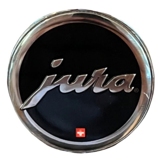 Close-up of a circular badge with the word 'jula' in cursive silver lettering on a black background and a small white cross at the bottom.