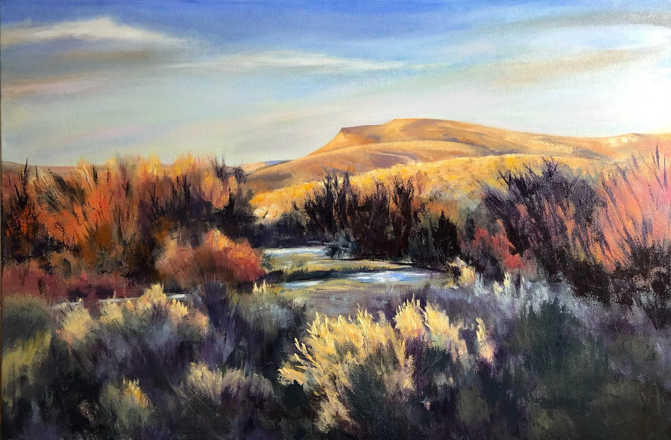 A landscape painting featuring a river running through autumn trees with yellow, orange, and red foliage. In the background, there are rolling hills under a partly cloudy sky.