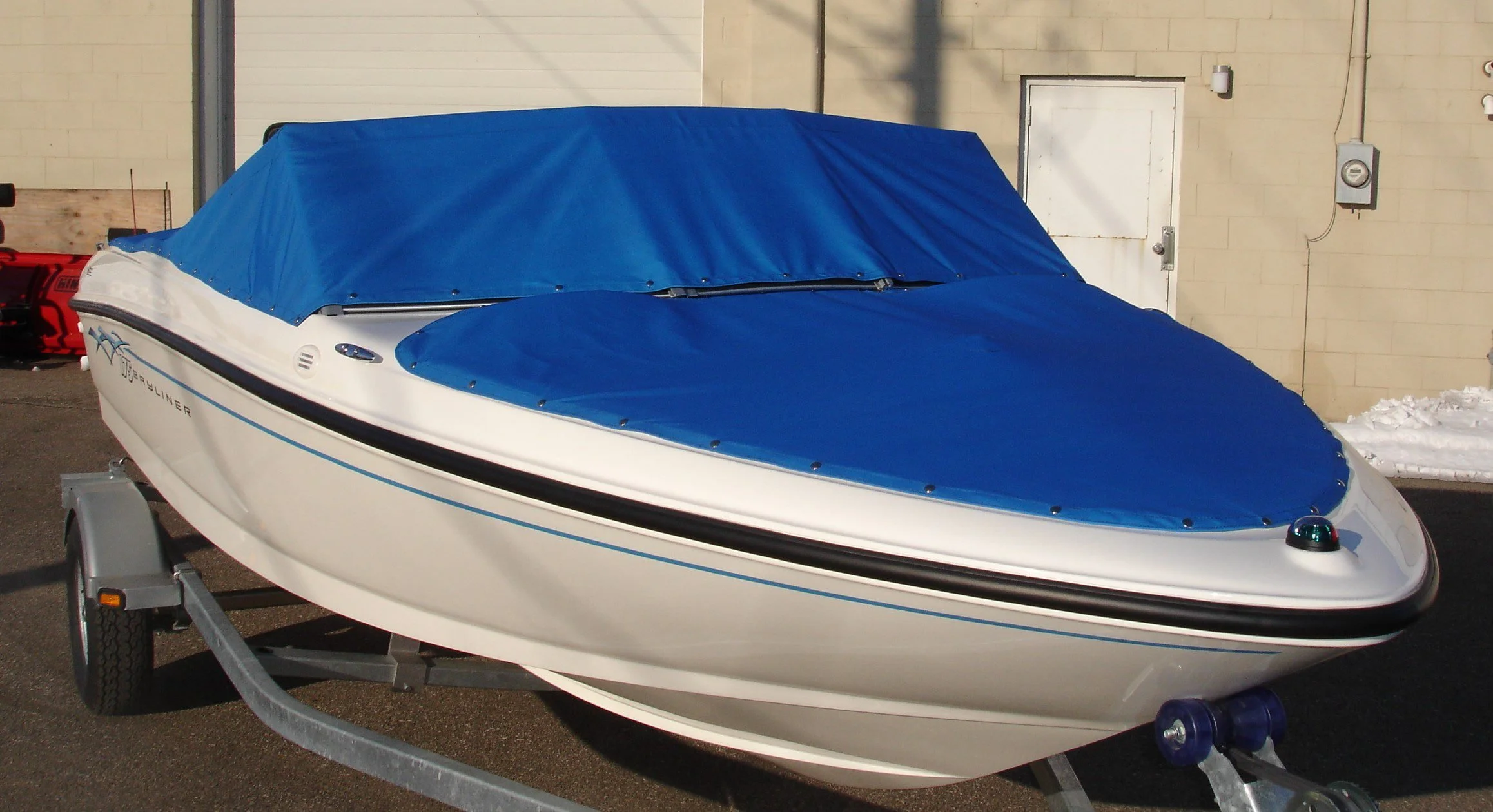 White and blue jet boat covered with a blue cover