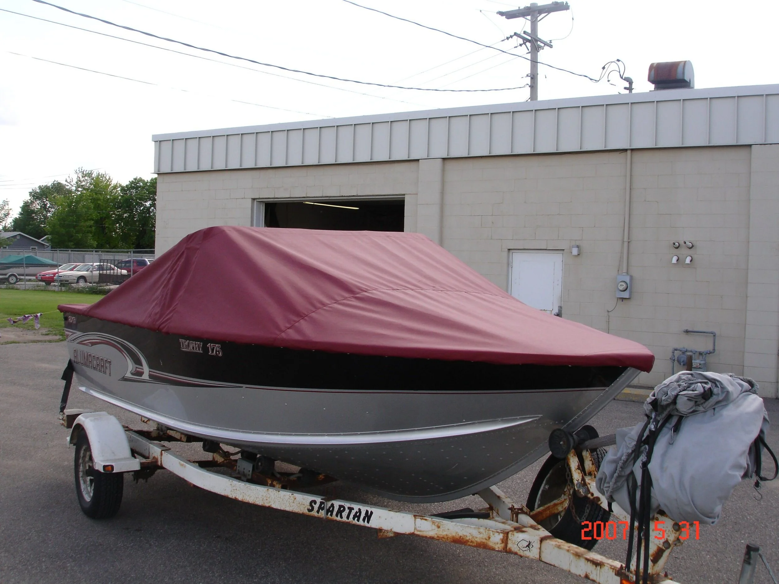 A maroon boat cover on a trailer 
