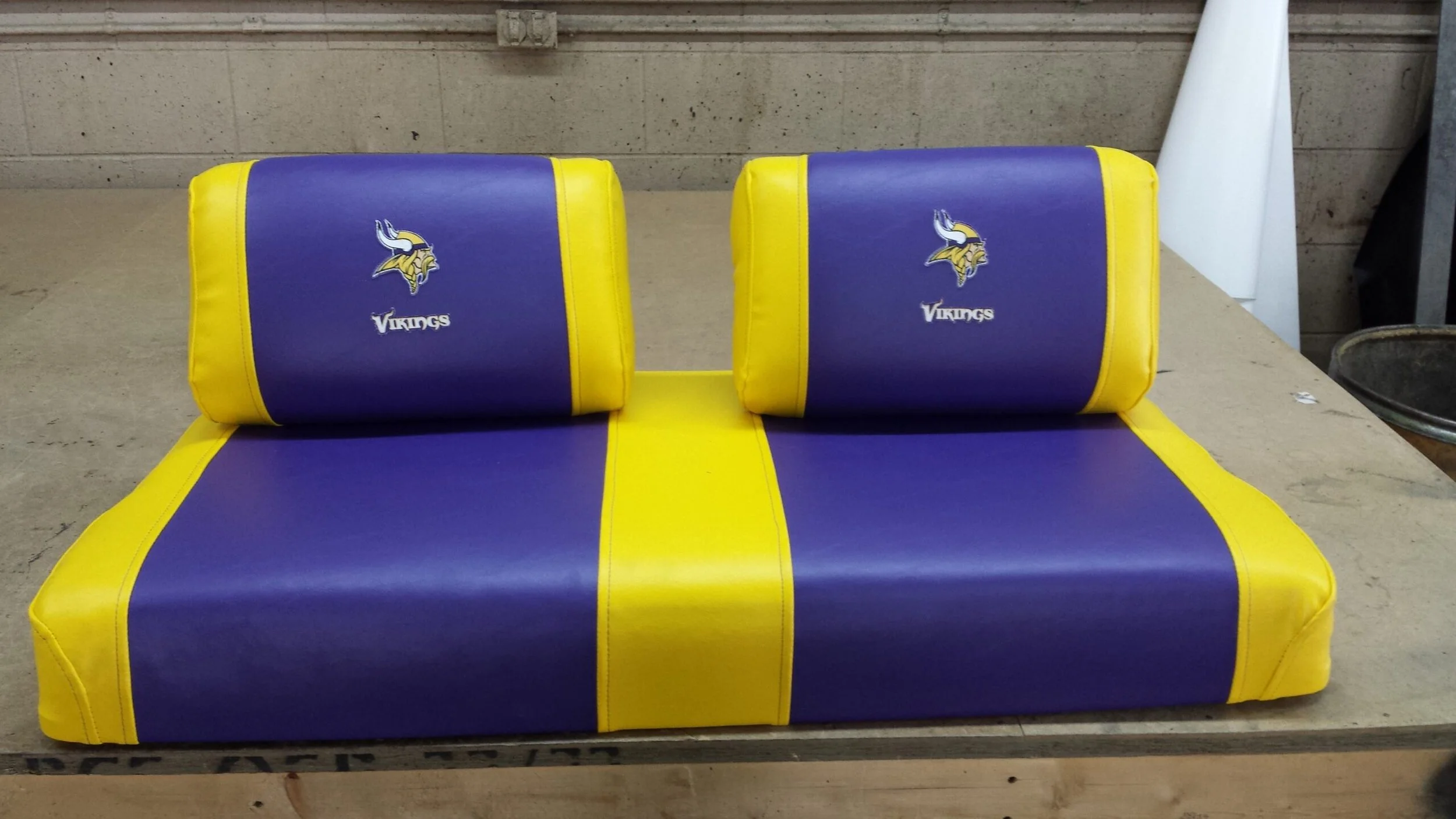 Purple and Yellow golf cart seat with Minnesota Vikings logo.