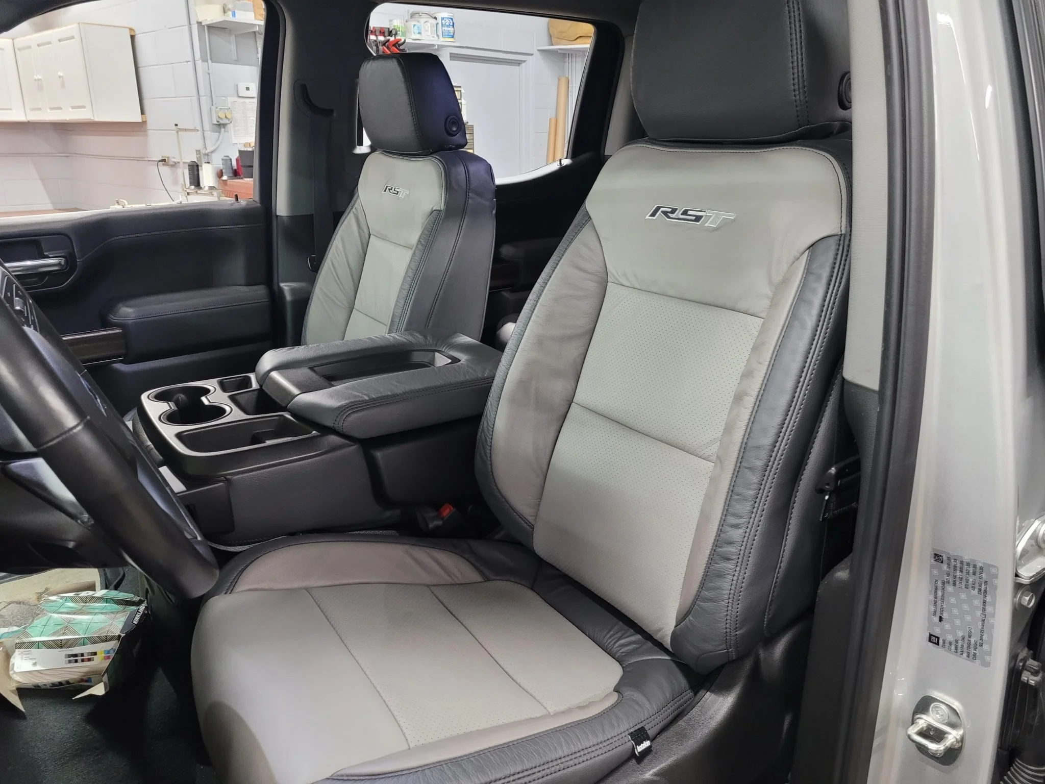 Front seats of a black vehicle, with the driver and passenger seats gray and black with "RST" embroidered on the headrests. Katzkin Leather Kit.