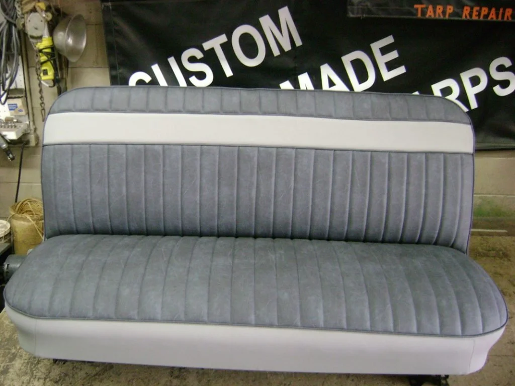 A vintage-style 2-tone gray bench seat with vertical pleats