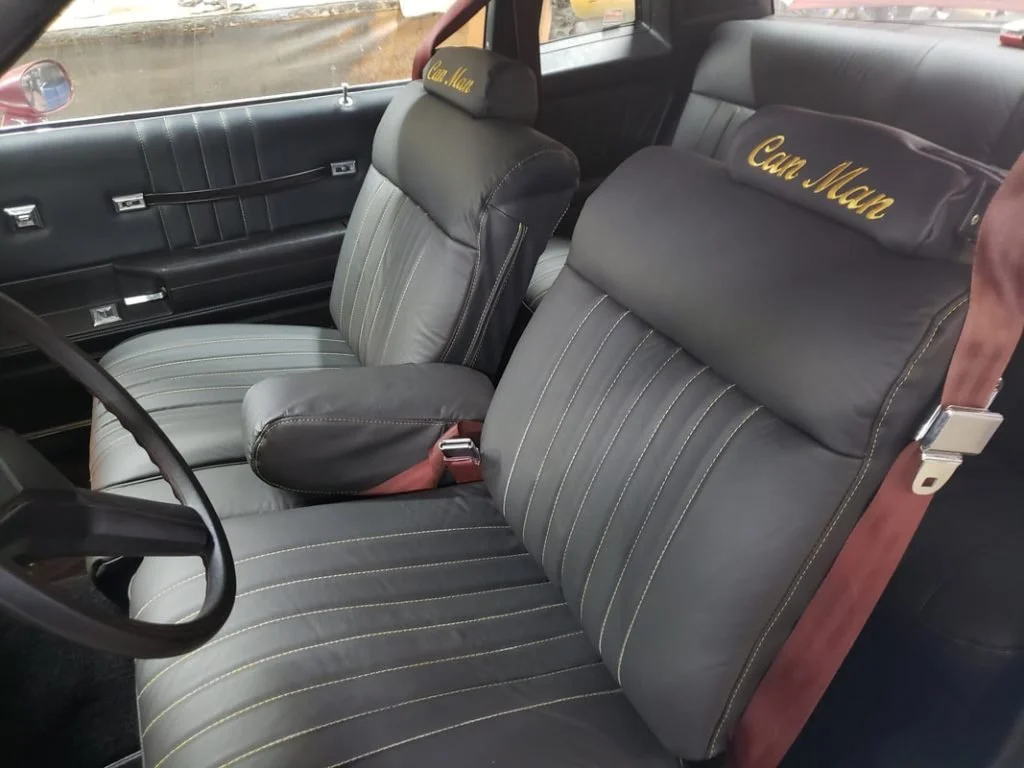 Black front and rear seats of a Monte Carlo with embroidery