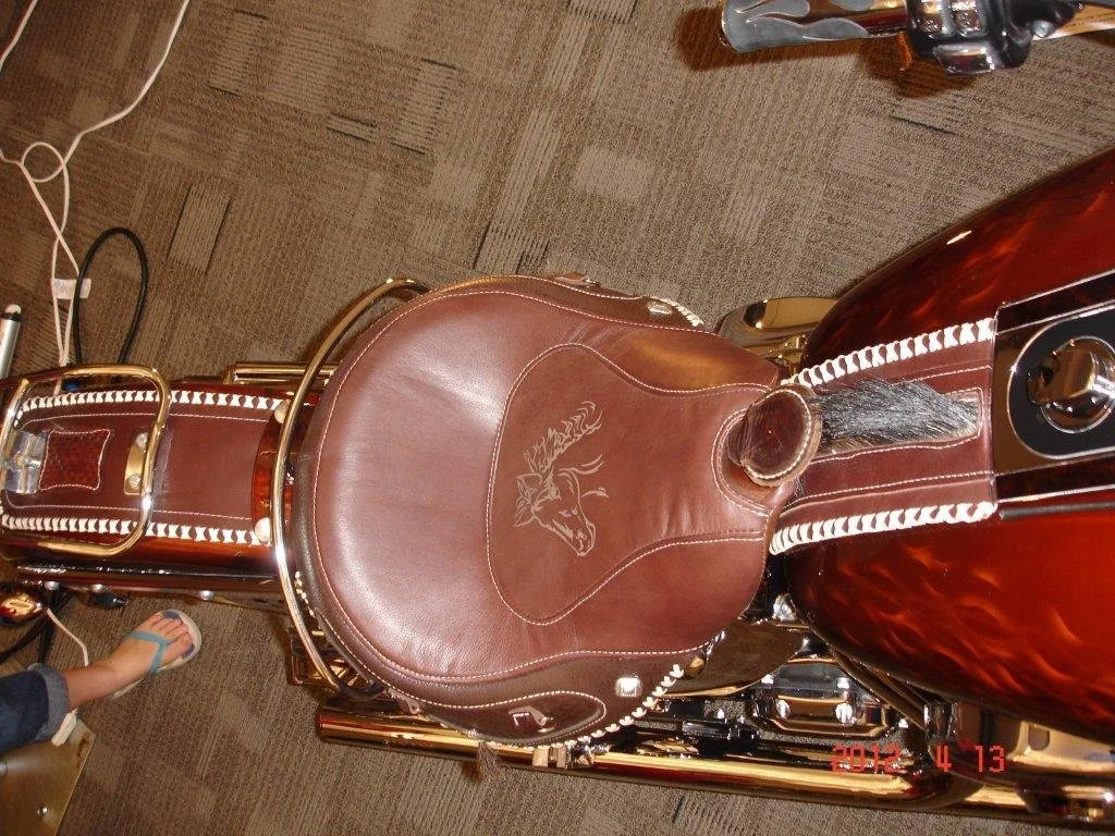 Top view of a leather motorcycle seat with a custom horse design, boar hair for mane.