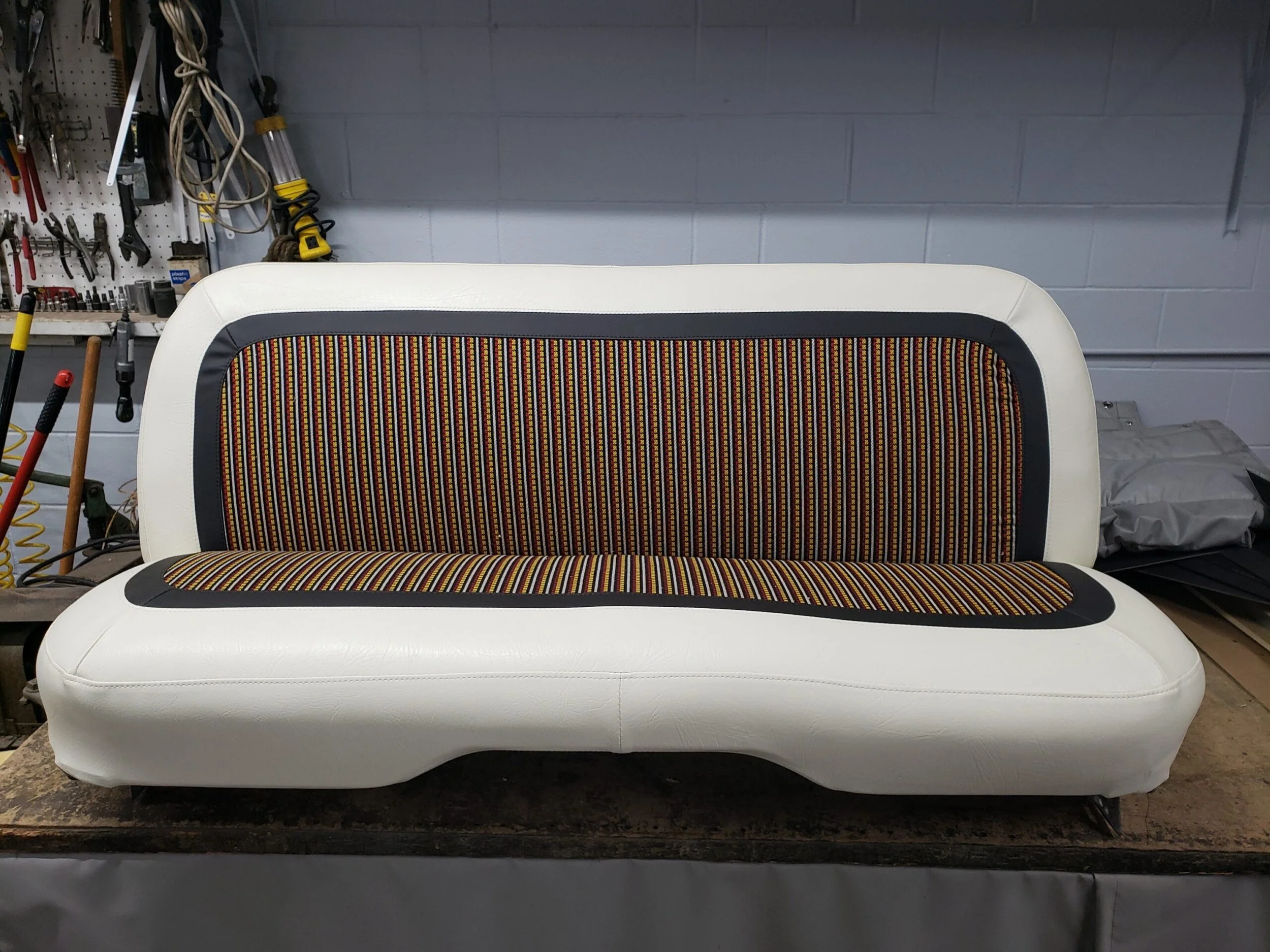 A white & brown vintage bench seat