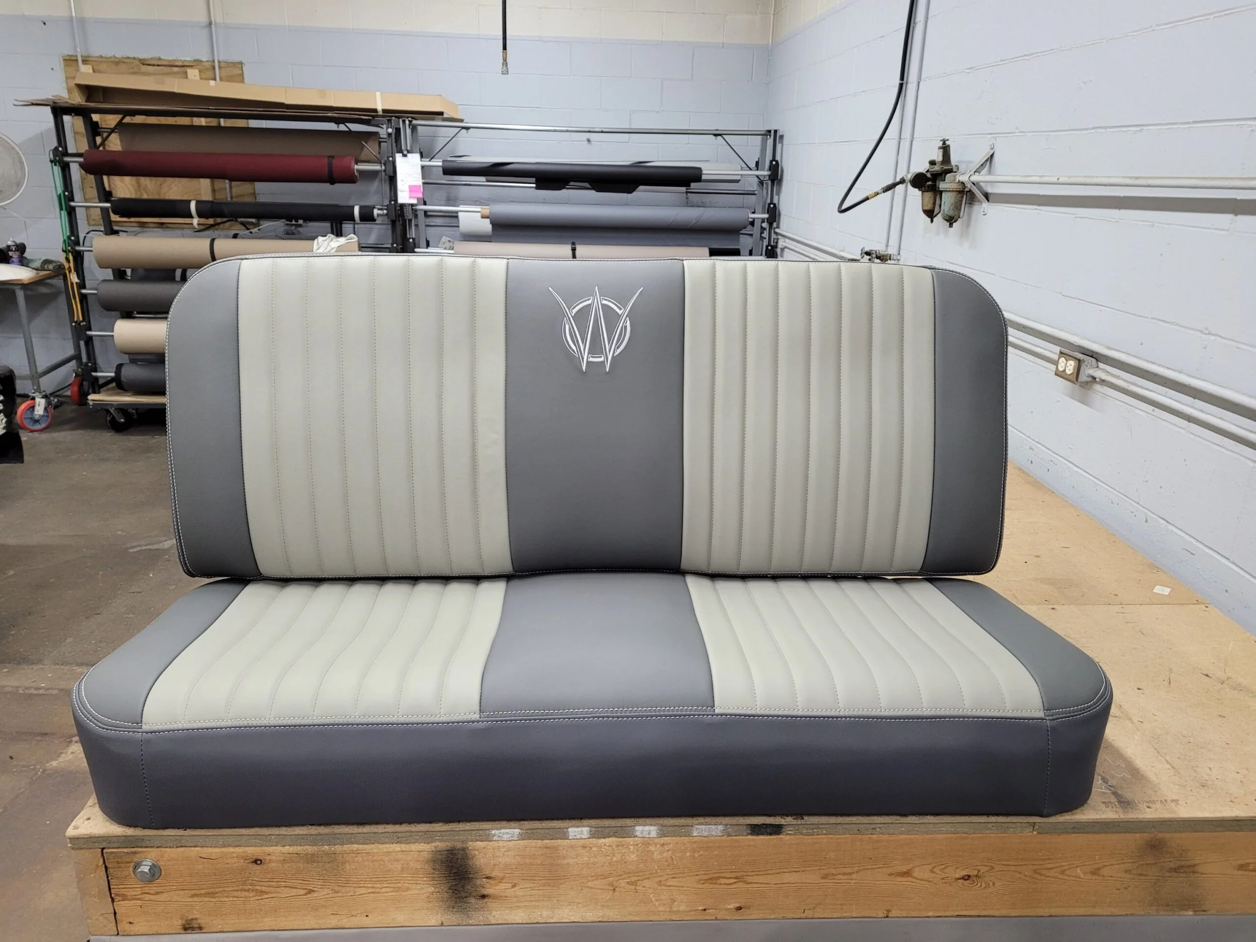 2 tone Gray Jeep Willy bench seat with a embroidered logo on the backrest.