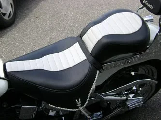 Close-up of a motorcycle seat with black and white upholstery