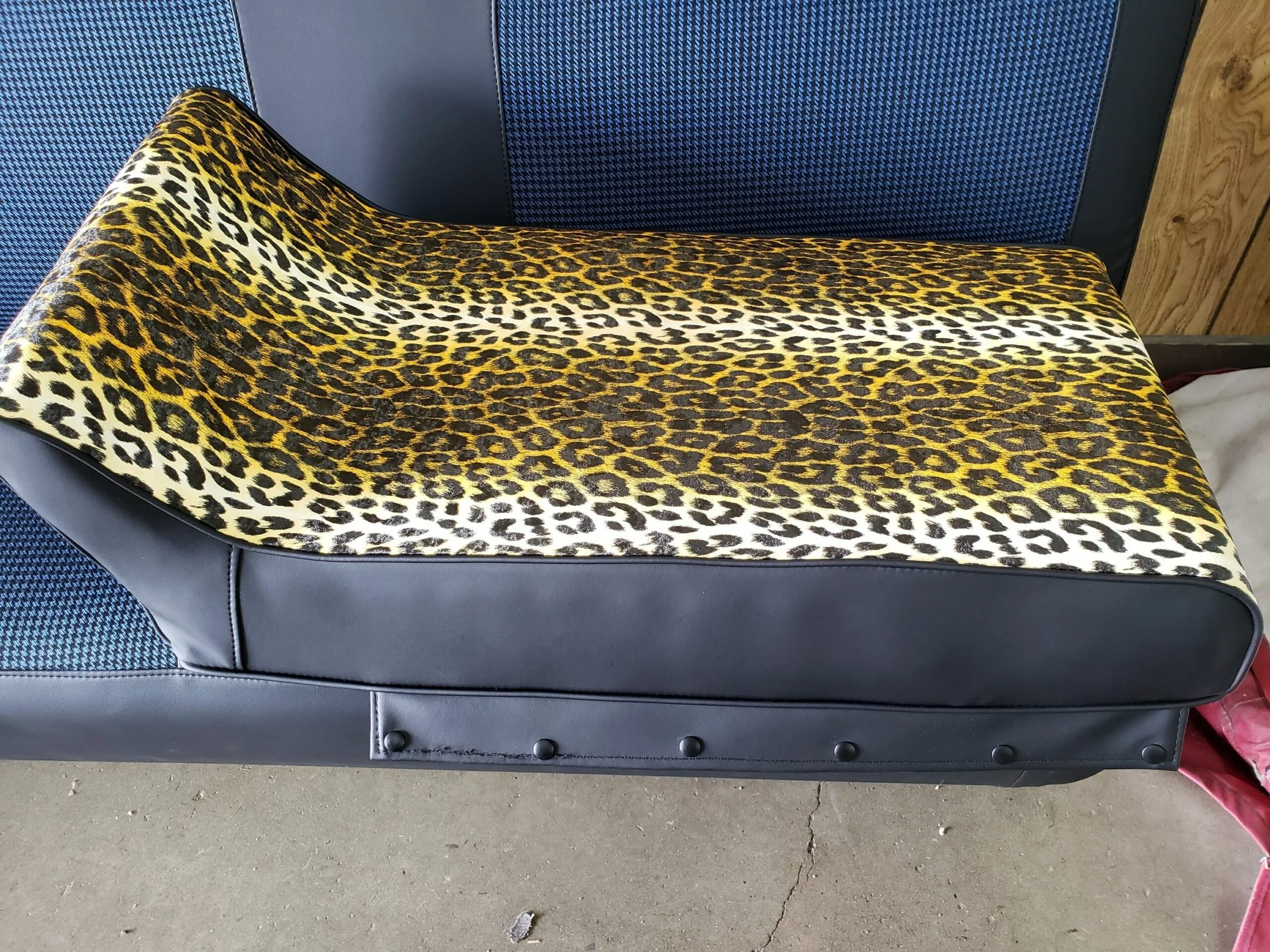 A vintage Arctic Cat seat with a leopard print 