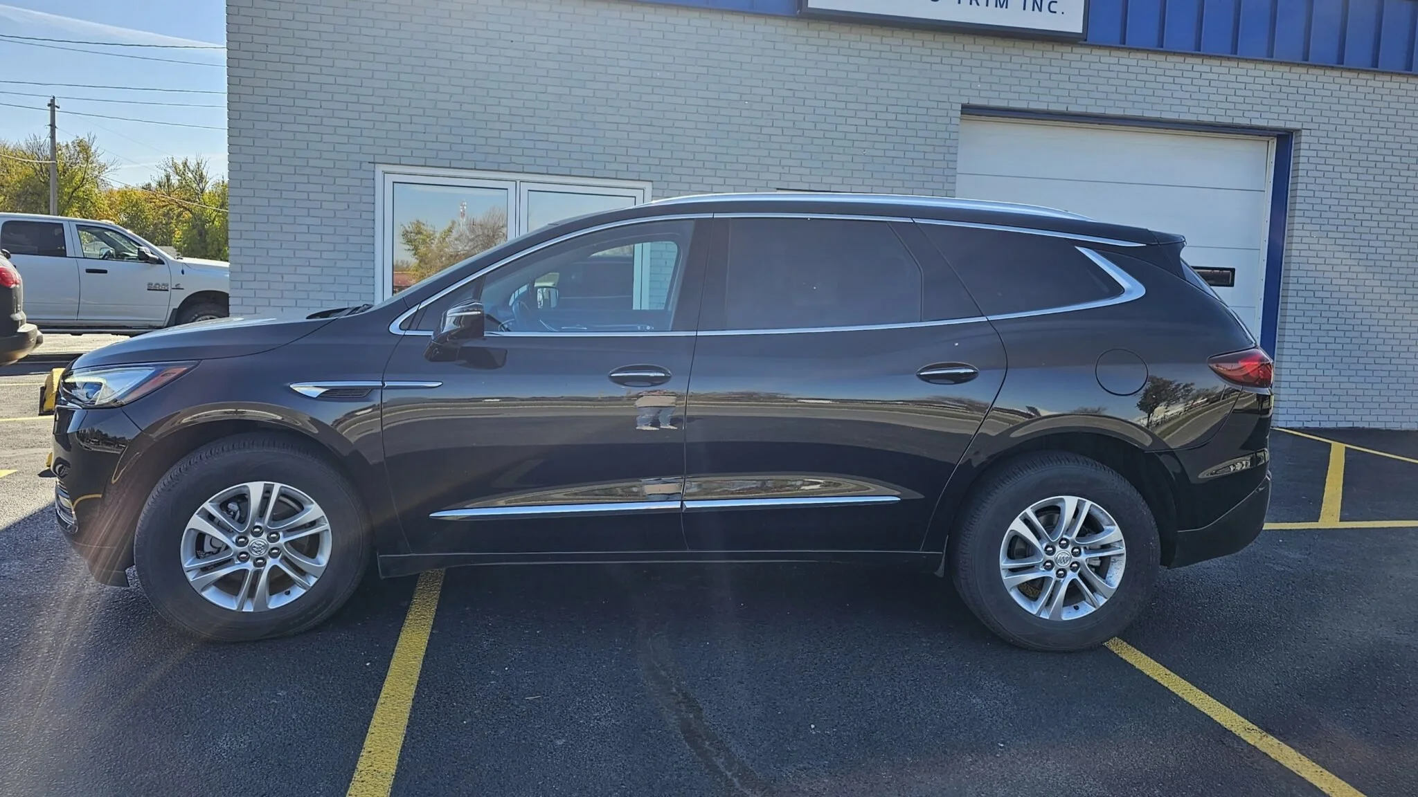 Black SUV parked in front of Finest Auto Trim, Inc, Owner Carmen