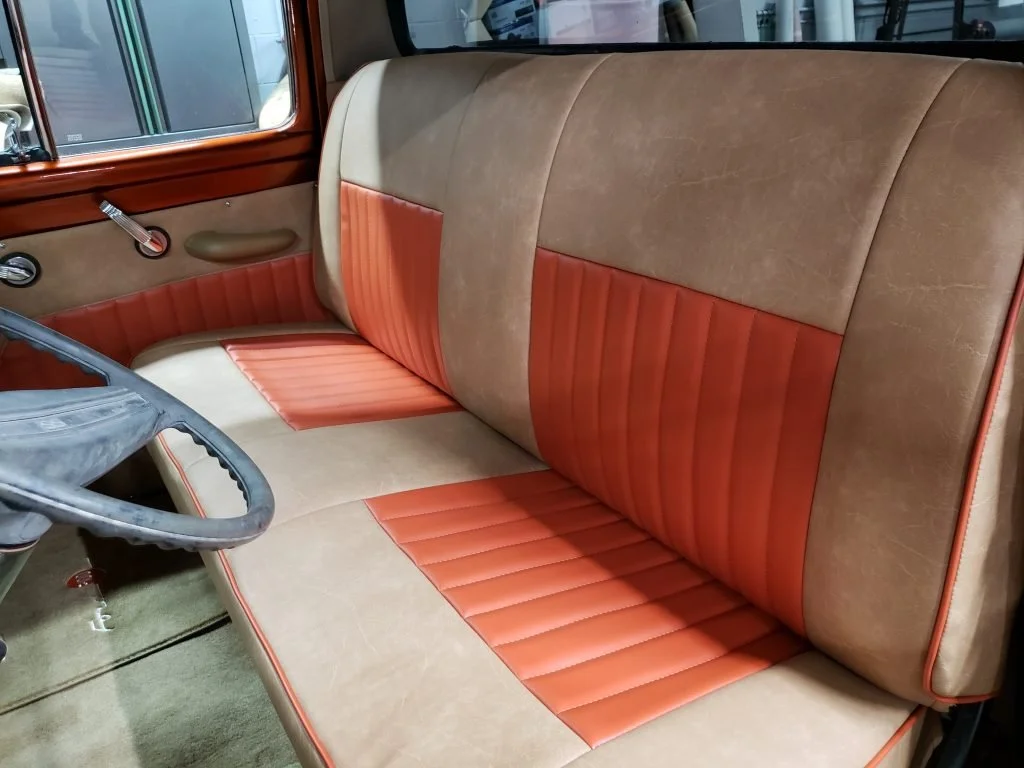 Vintage truck with a two-tone tan and orange bench seat