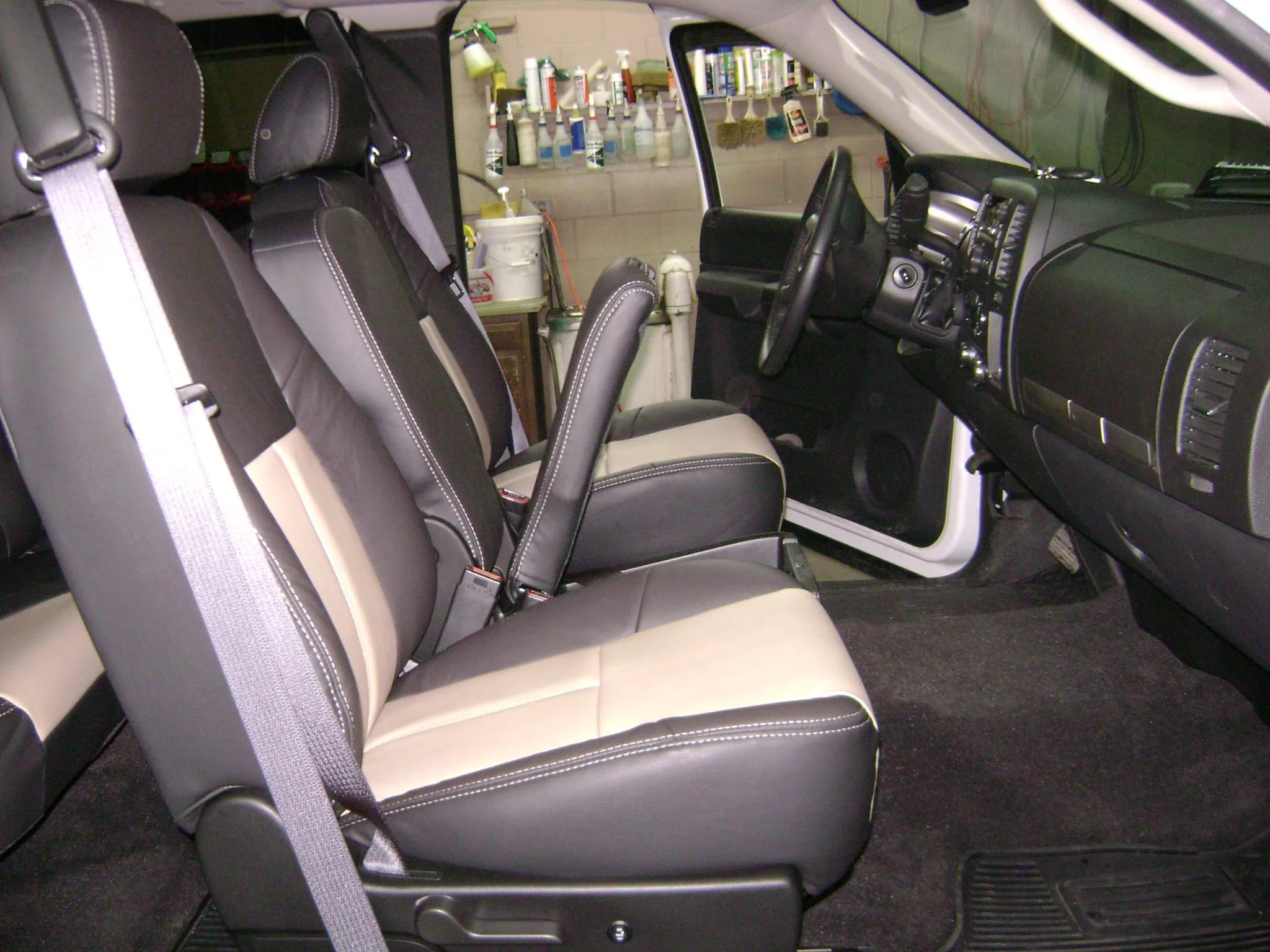 Interior of a vehicle with black and tan leather seats, Katzkin Leather Kit.