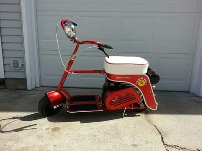 A vintage red and white electric scooter 
