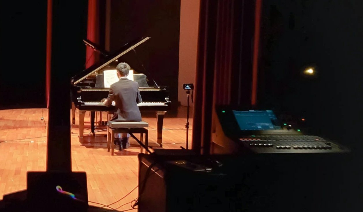 Pianist performing onstage.