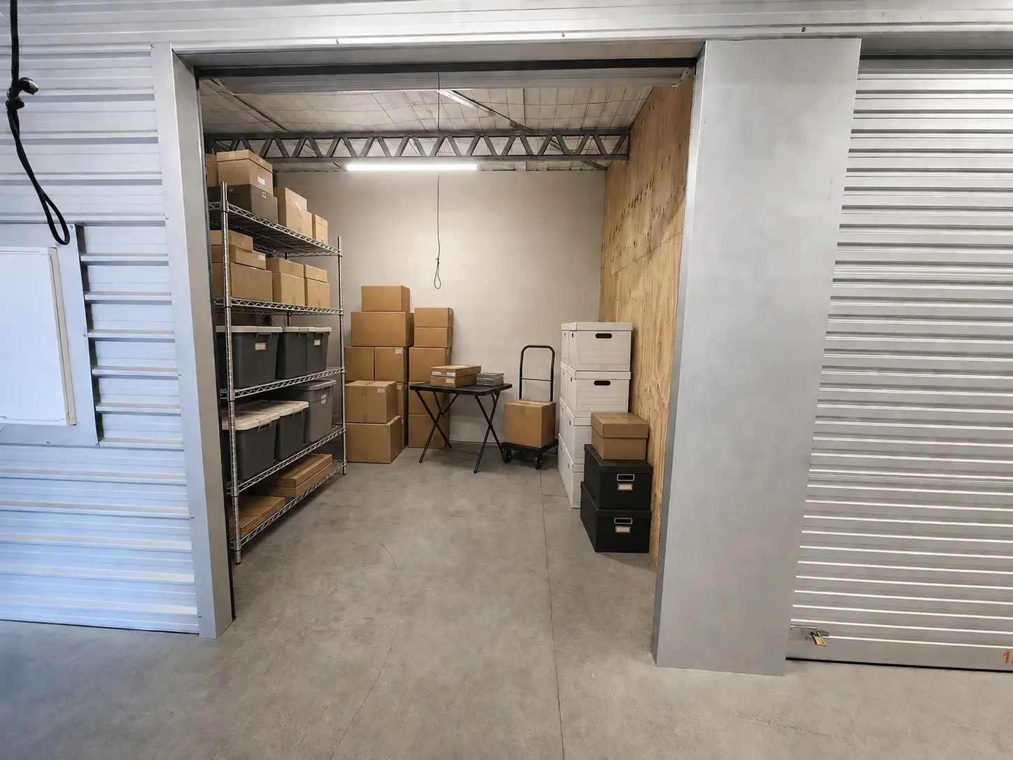 Boxes, archive files and retail stock organised inside a small-business storage unit at Myt4you Storage Ravenswood