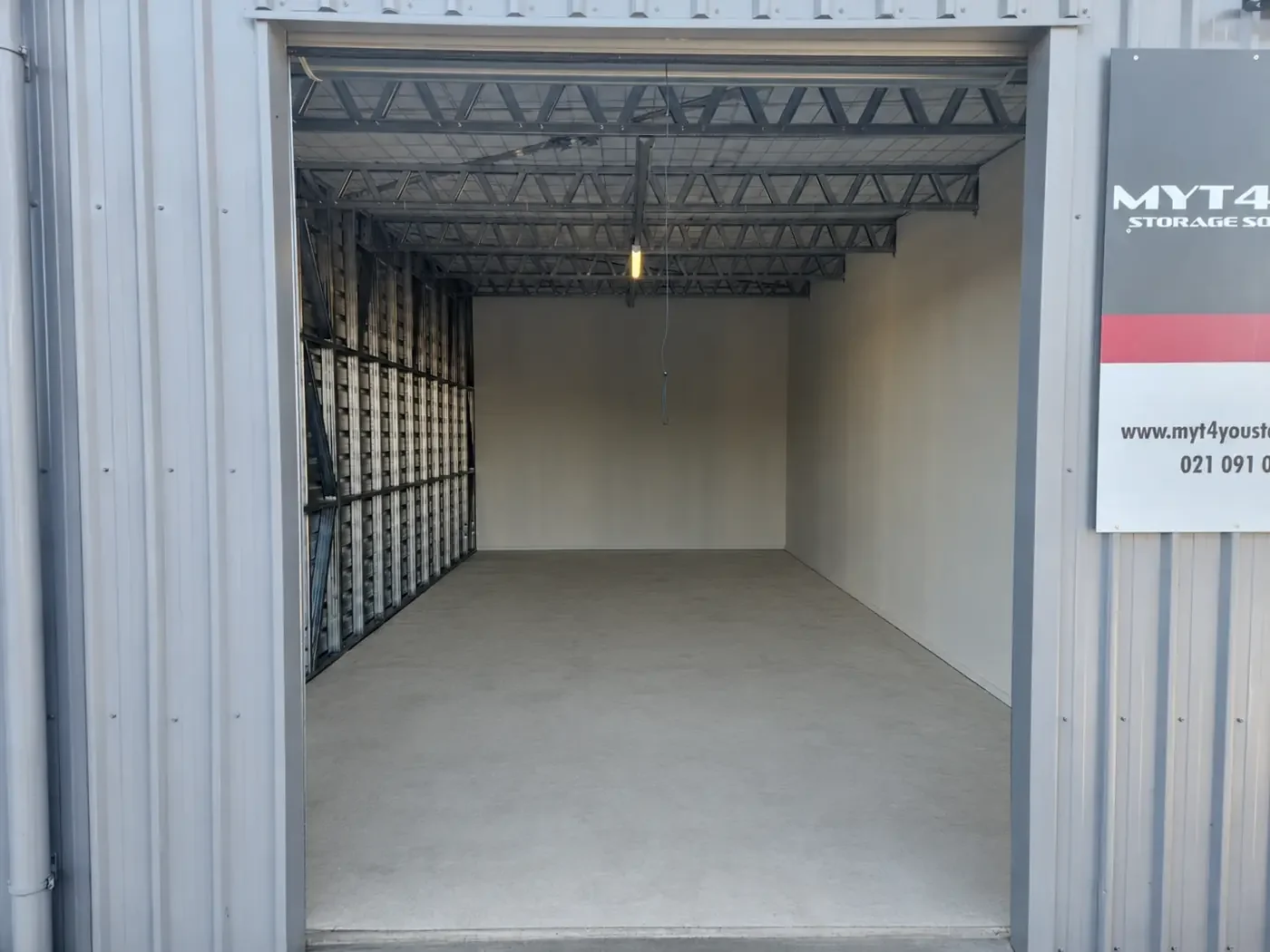 Empty 45 m² large storage unit with lighting and drive-up access at Myt4you Storage Ravenswood