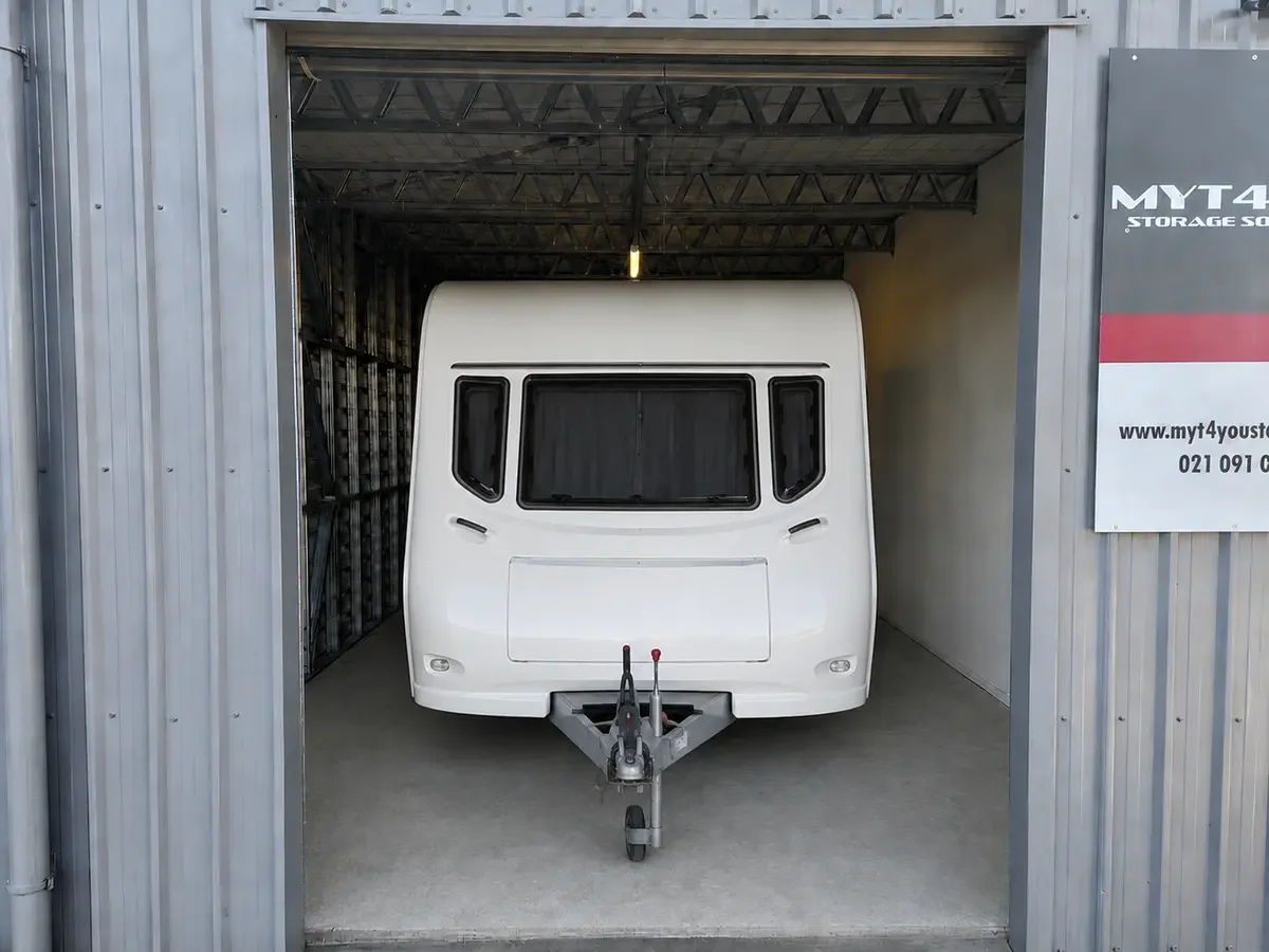 Caravan stored inside a clean and secure drive-up storage unit in Woodend, North Canterbury