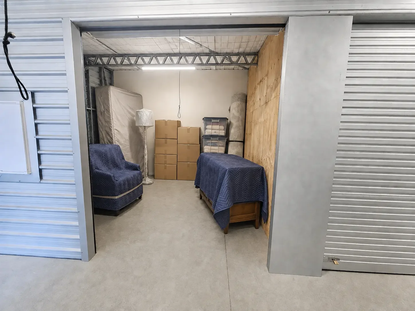 Covered furniture and mattress protected inside a storage unit at Myt4you Storage Ravenswood