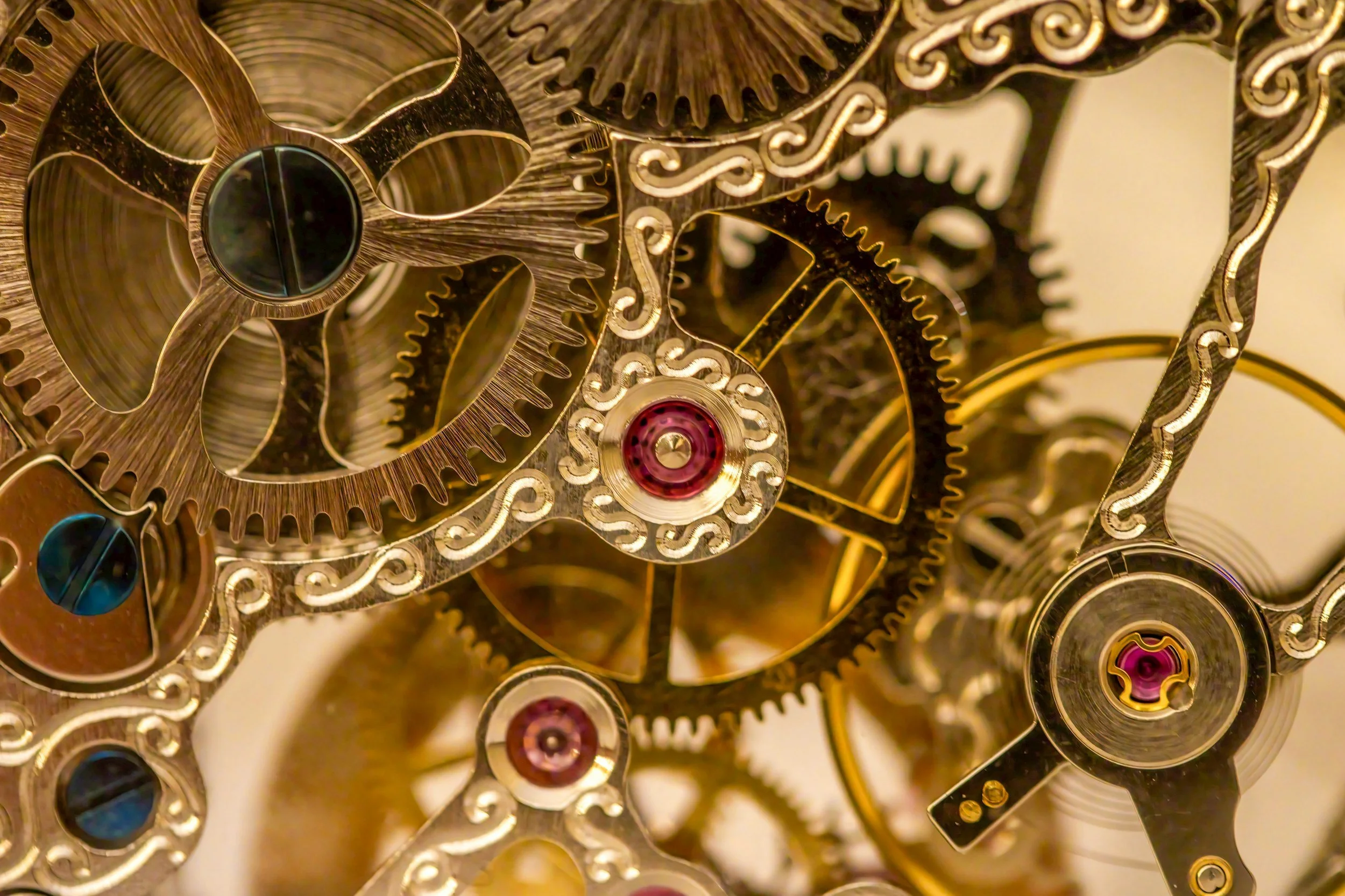 Close-up of the intricate gears and mechanisms inside a gold-colored watch movement.