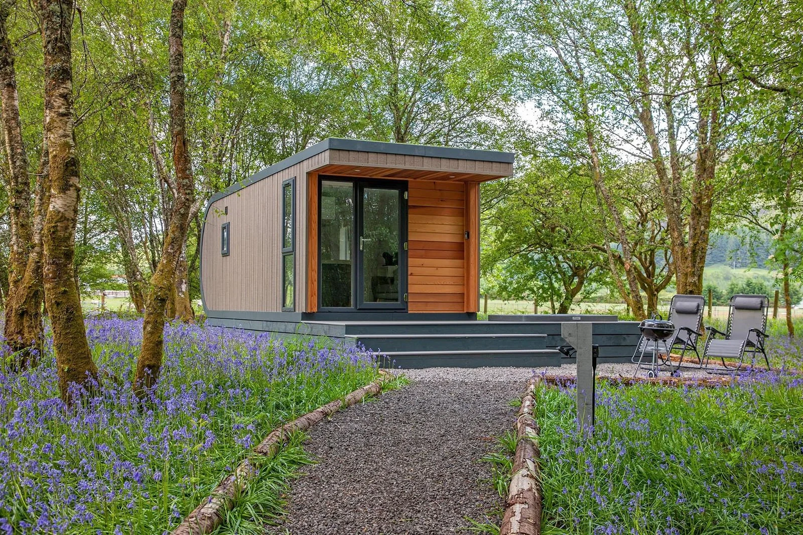 Garden office constructed from SIP panels with cedar cladding in a woodland location.
