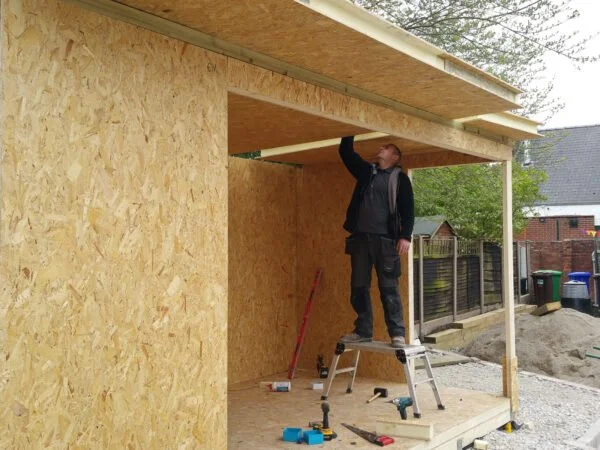 MAI Garden Rooms team installing the SIP panel structure.