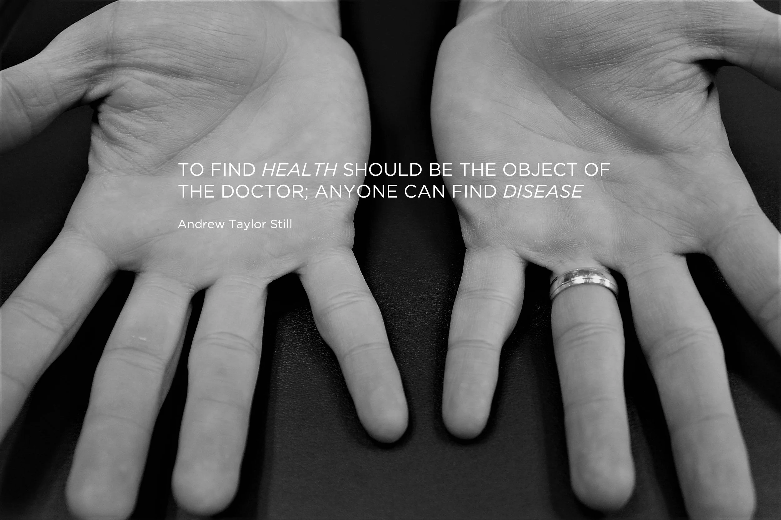 Black and white photo of two hands with fingers spread, showing rings on the ring fingers of each hand, and a quote overlayed on the image.
