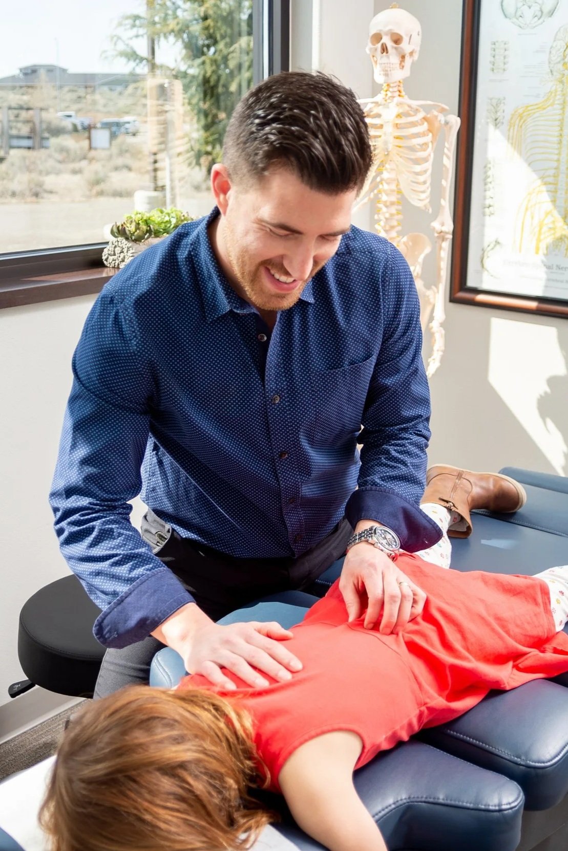 Dr Kyle performing an adjustment on a pediatric patient at ICE