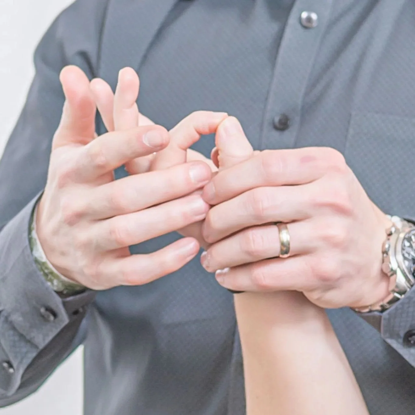 Dr Kyle performing an extremity assessment on a patient's hand