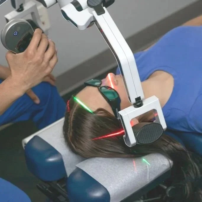 A patient with a concussion receiving low-level laser therapy at ICE Clinics