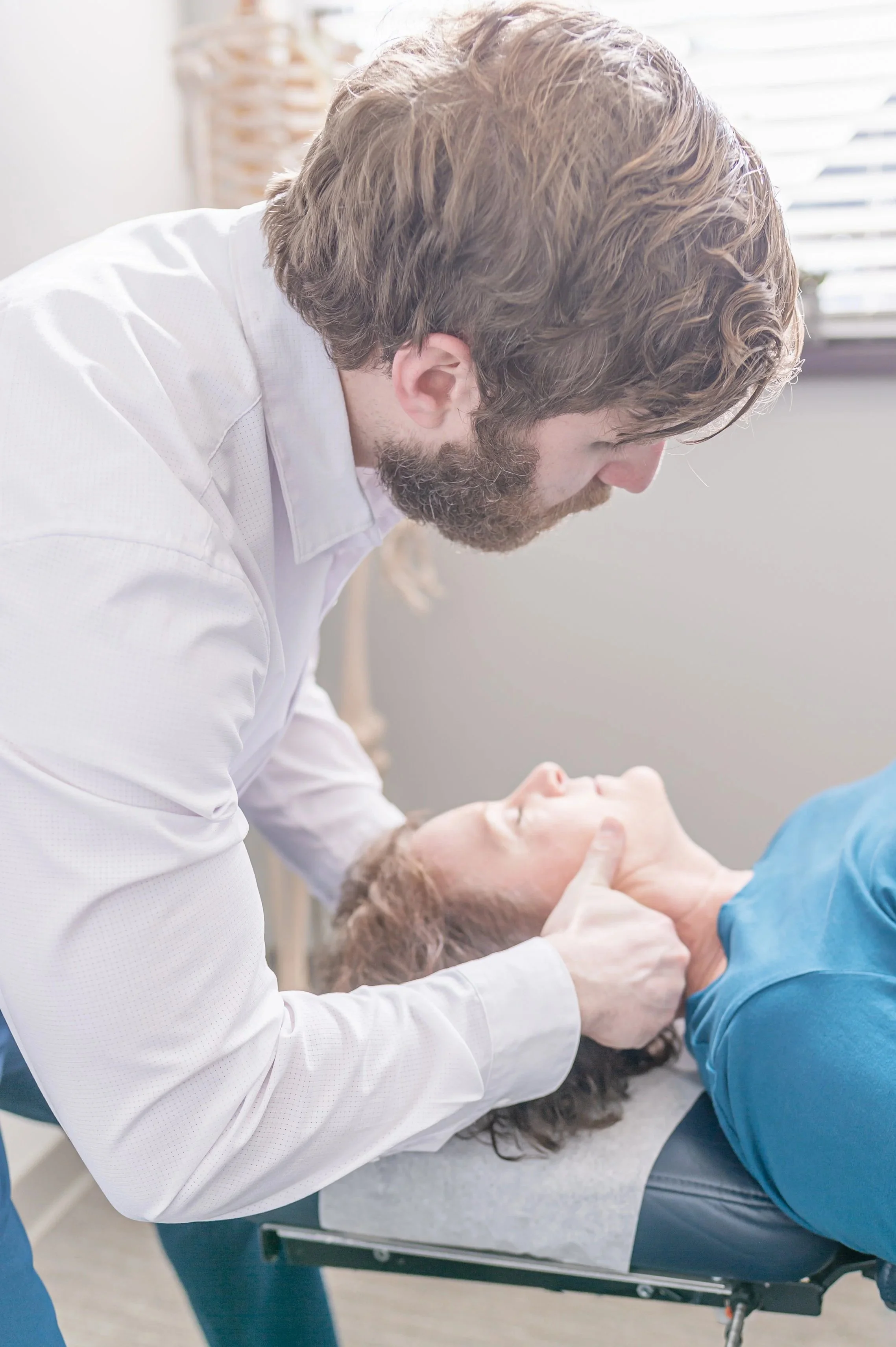 Dr Joe adjusting the neck of a patient at ICE