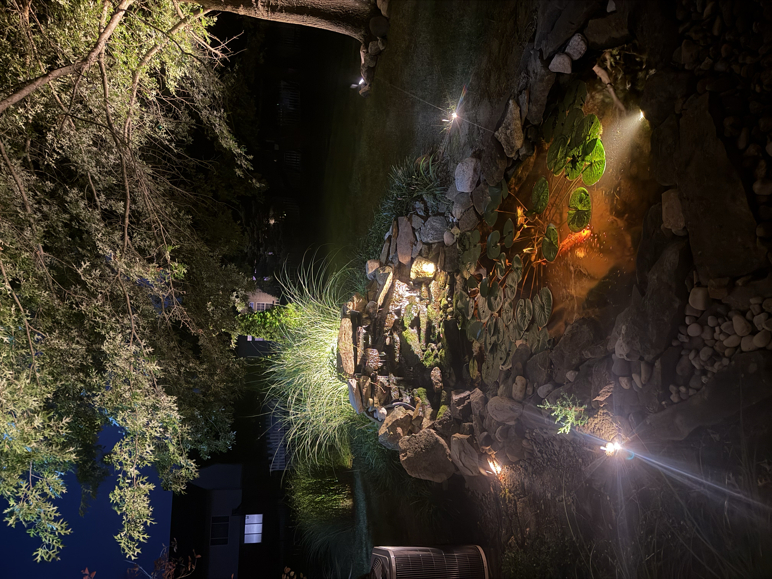 Koi pond accent lighting and also submerged underwater illumination.  Notice the 2700k powerhouse mini lights that are buried and making them completely hidden during the daytime but robust in the dark.  