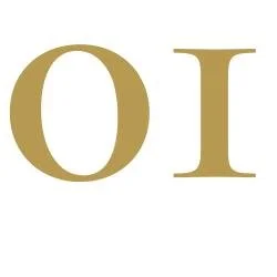 Close-up of a gold-colored 'O' and 'I' on a white background