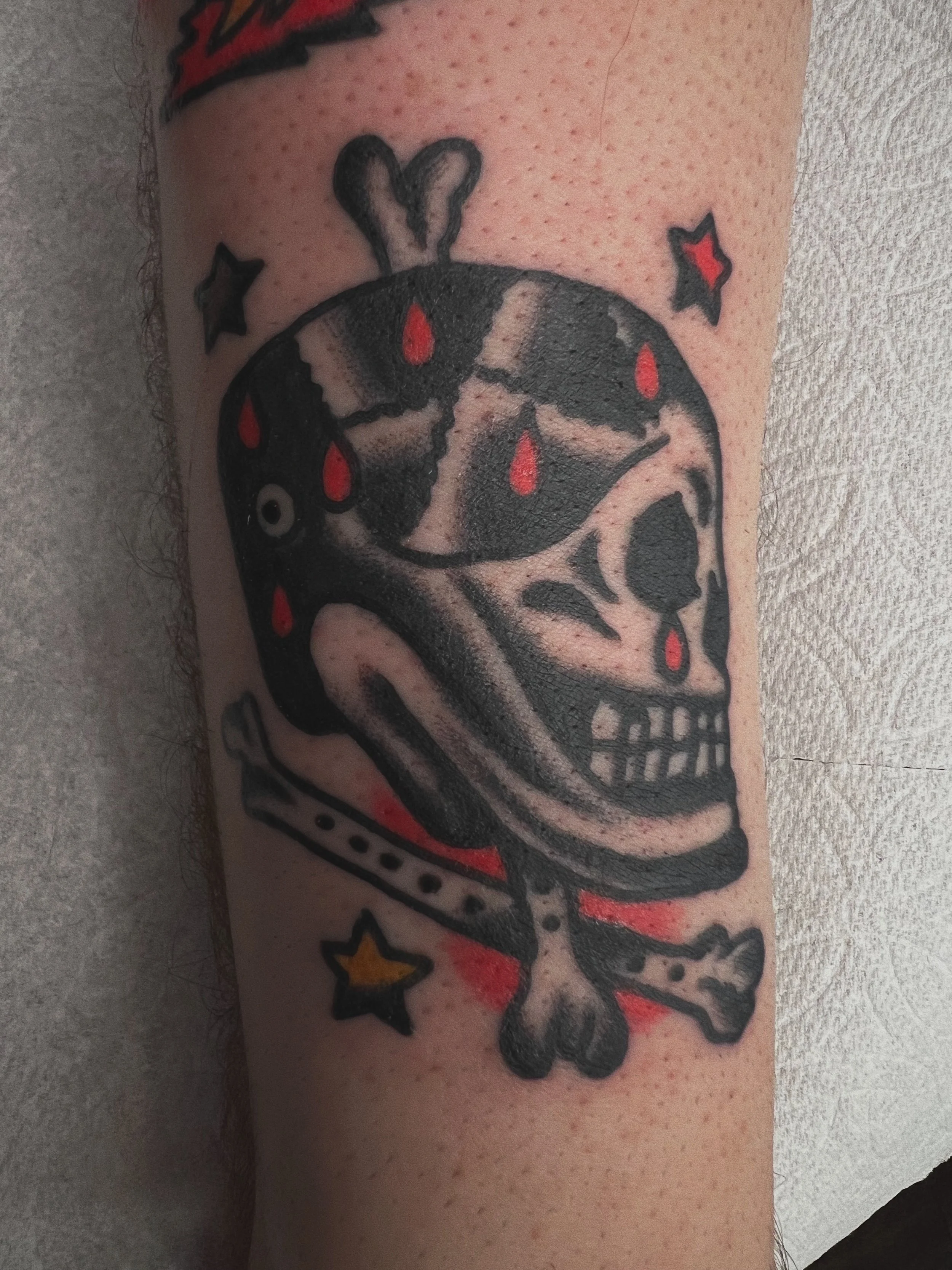 American Traditional skull and cross bones tattoo 