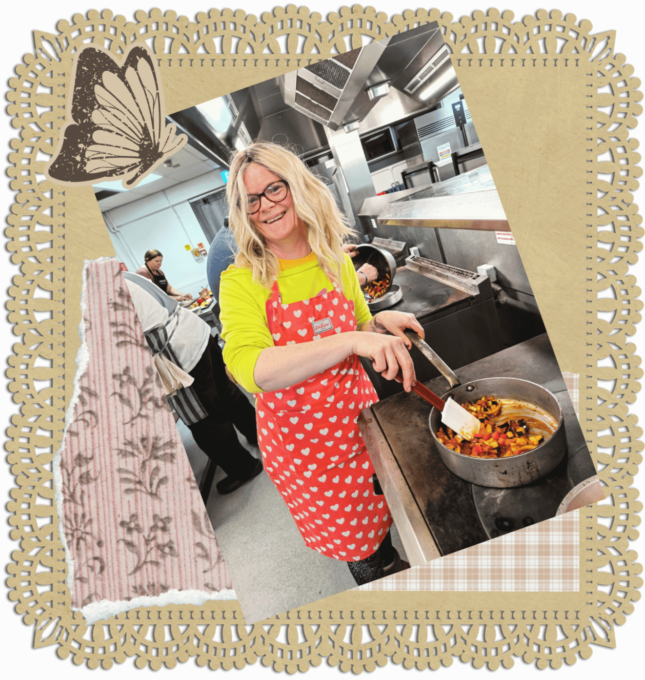 Helena, owner and founder of Helrica, a bright yellow long sleeve shirt cooking vegetables in a pan in a commercial kitchen, wearing a red apron with white hearts, demonstrating that life starts at over 40 and you are fabulous.