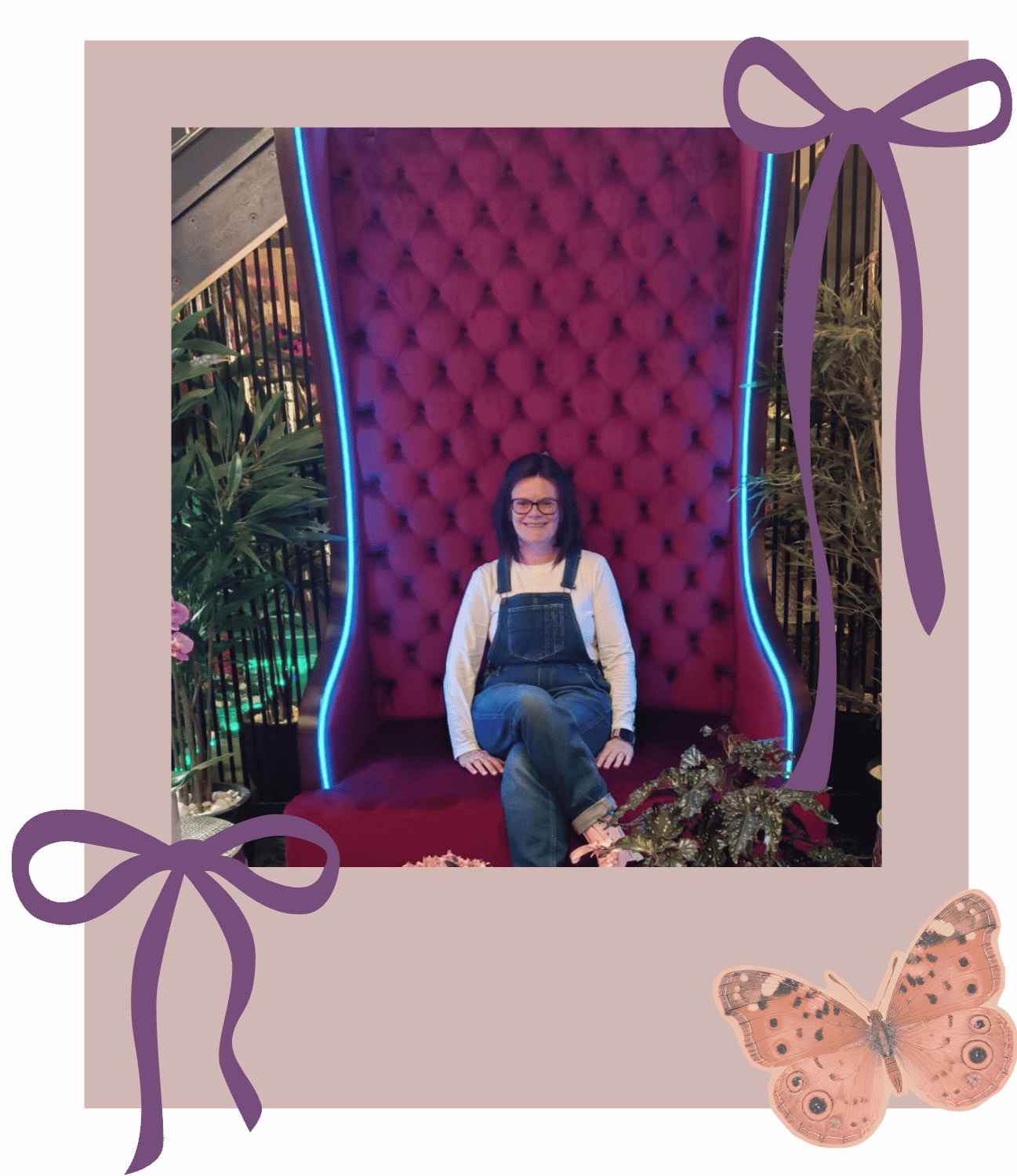 Helena sitting on a large, red, tufted throne-like chair with neon blue lighting on the edges demonstrating confidence and emotional wellbeing