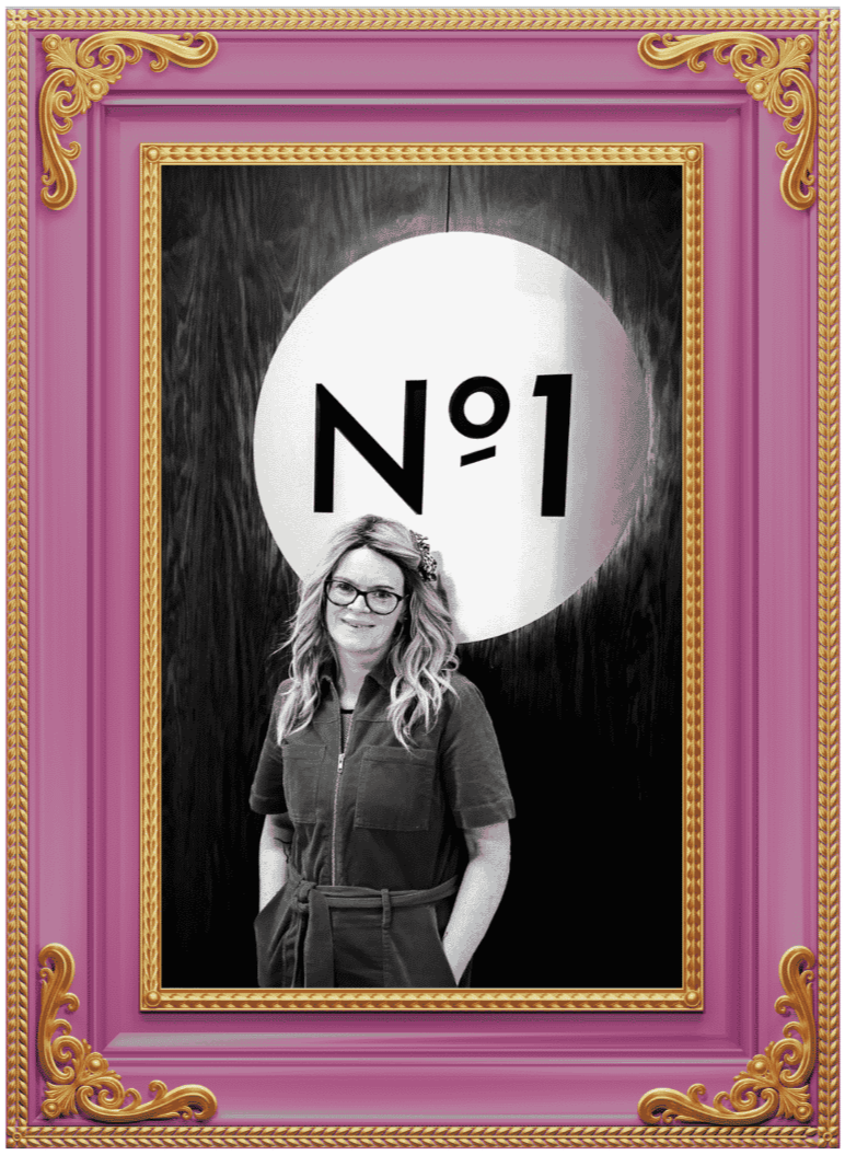 Helena photographed beside a Number One award display, reflecting learning, growth and professional development.