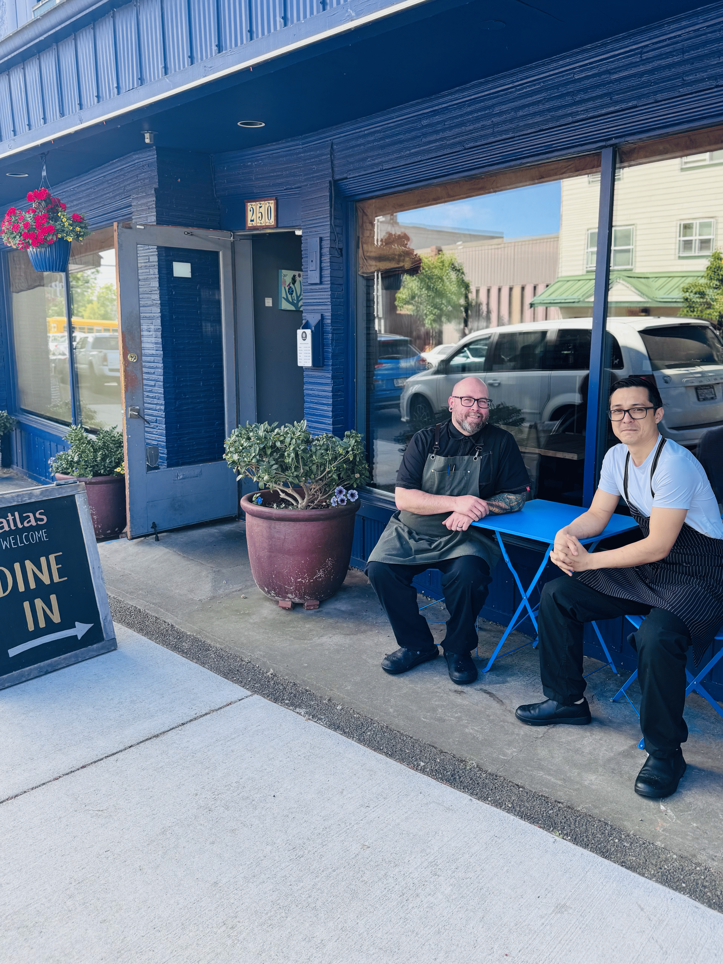 Chef Ryan & Sous Chef Alec sitting in front of Atlas Cafe.