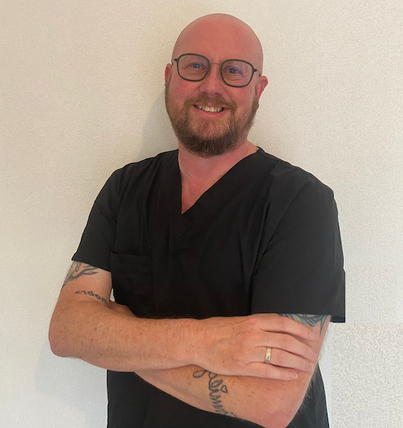 Image of Bear in black scrubs