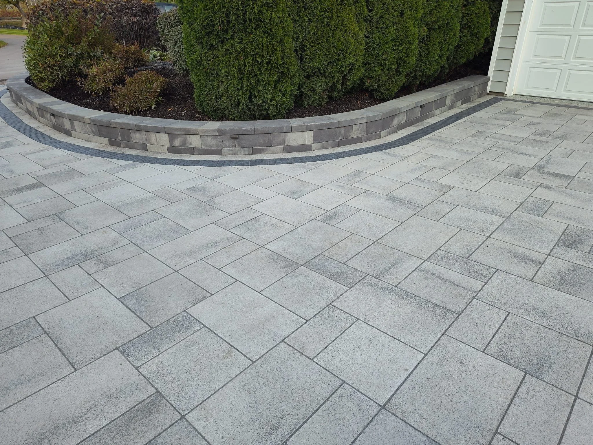 A freshly done driveway with stone pavers really does make the difference Synergy Lawnscape loves to deliver. 