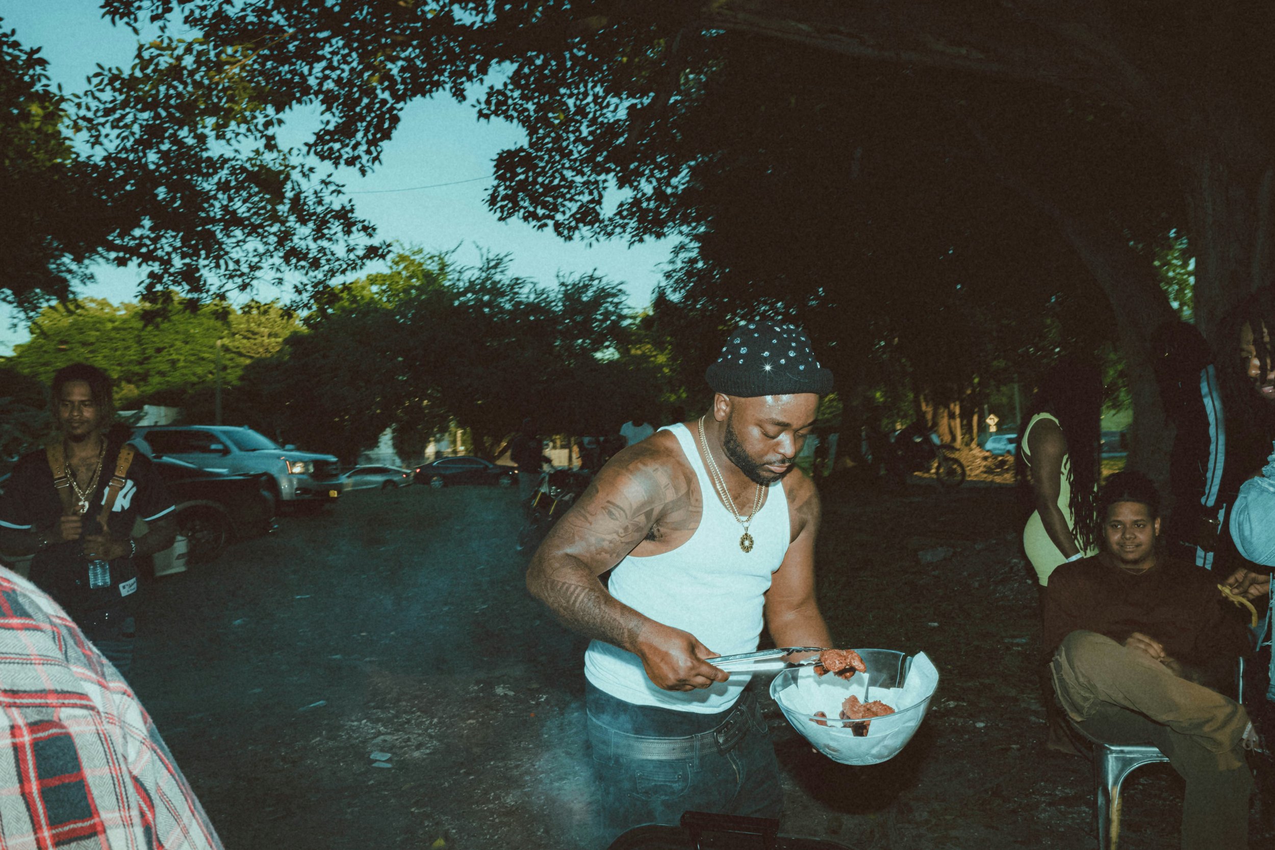 Family and friends gathered for a cookout in the American South, cooking and eating together"