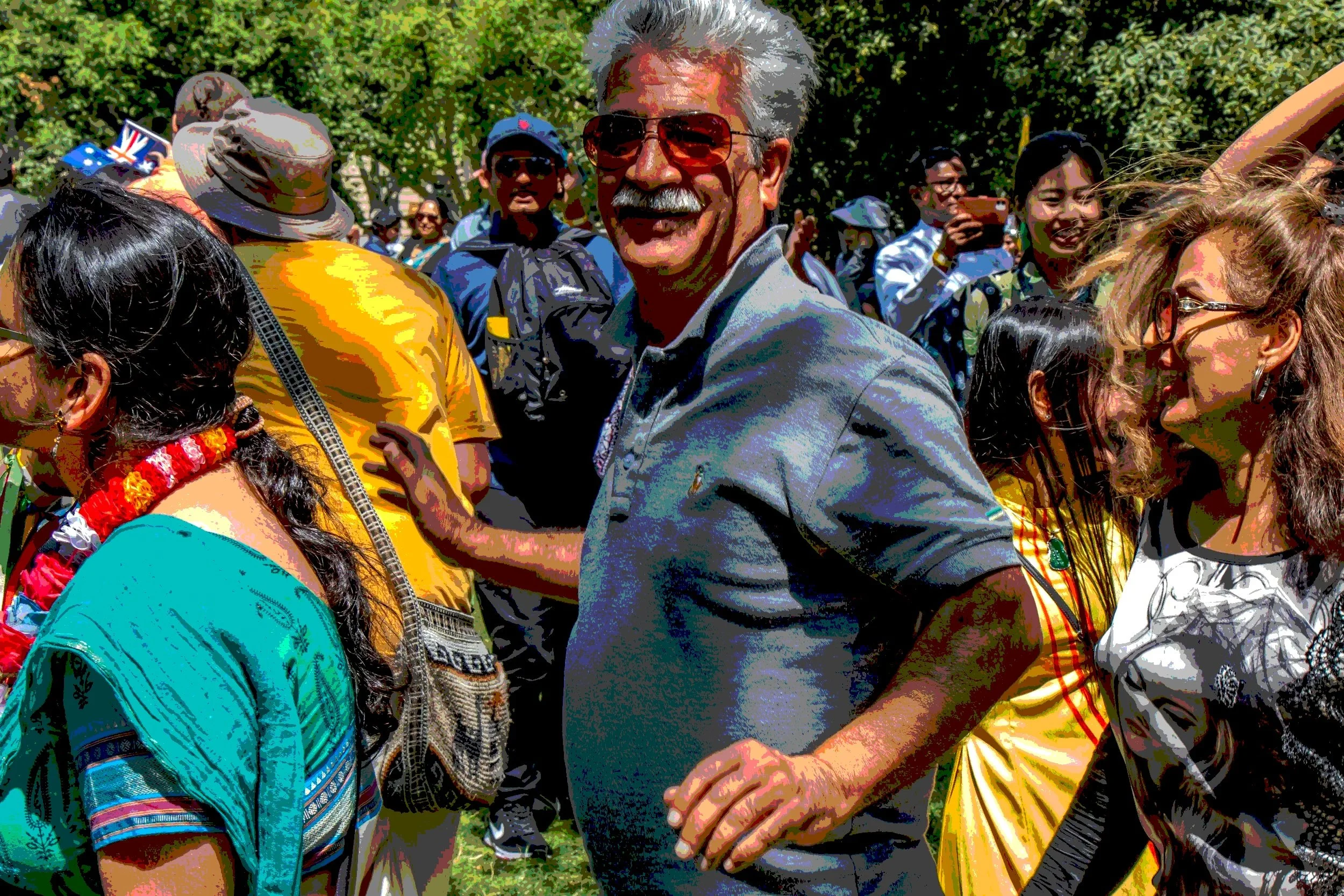 Diverse group of people gathered outdoors, smiling and interacting together