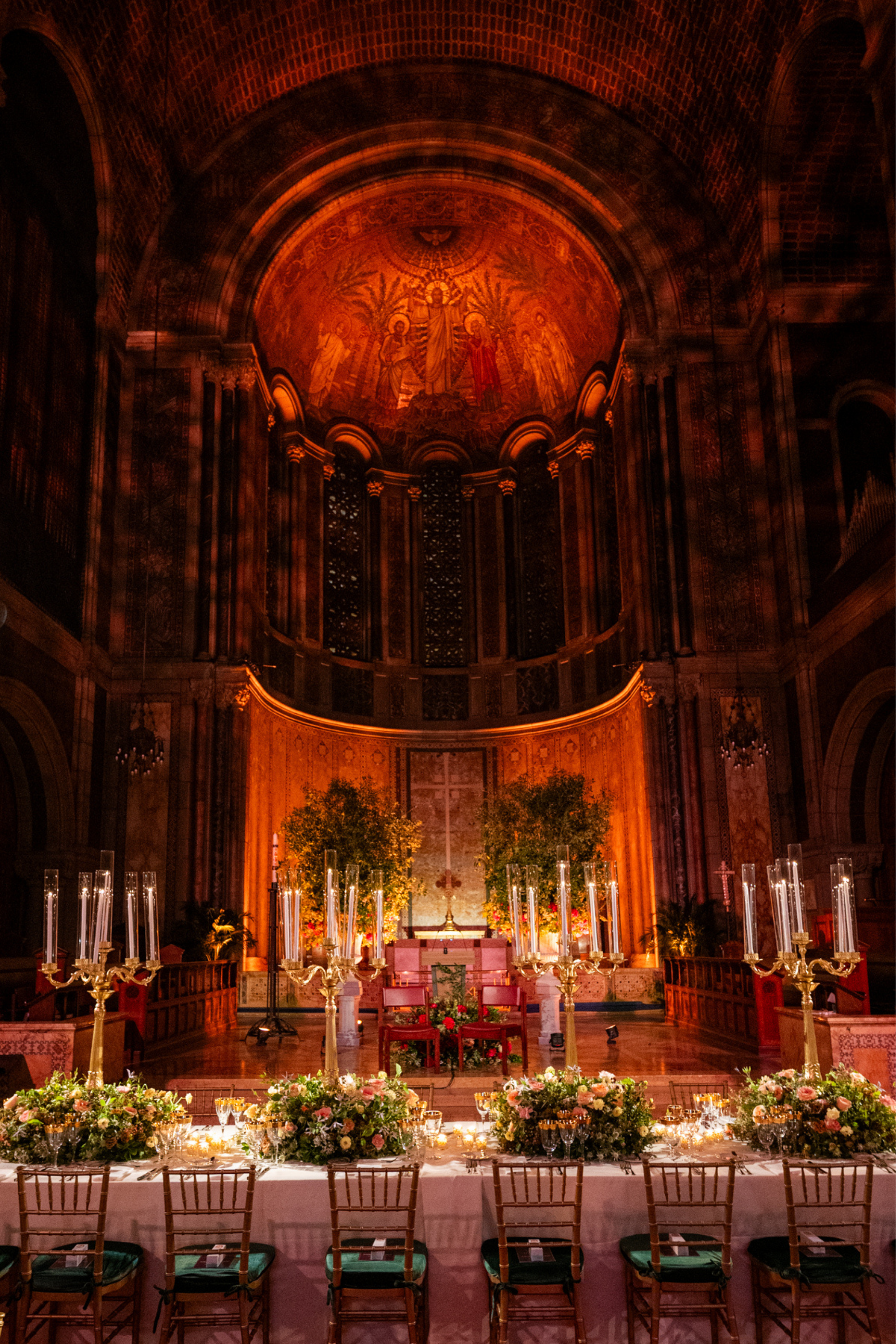 Elegant wedding reception table styling inside a historic church venue with candles and floral arrangements
