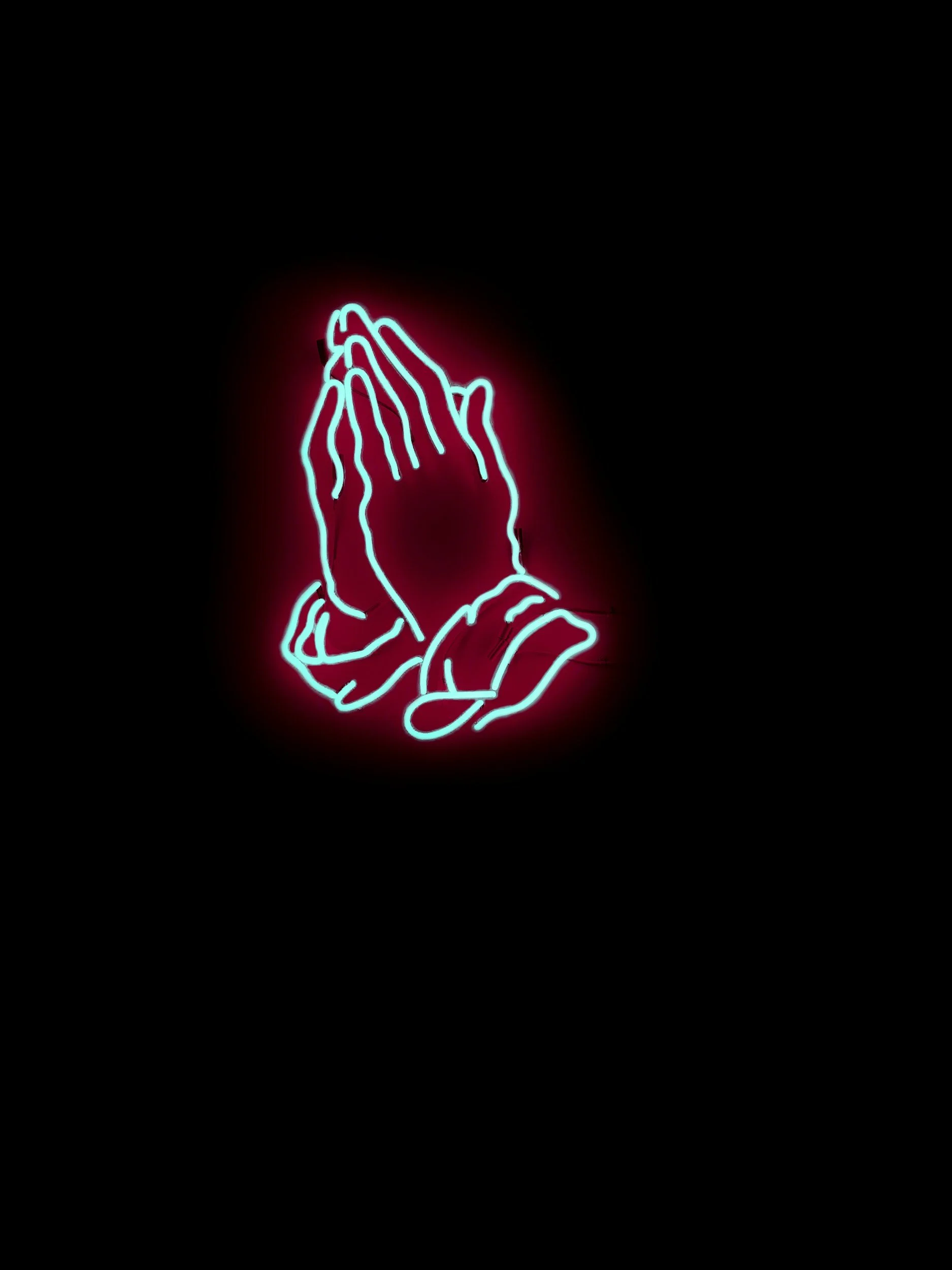 Neon sign of praying hands against dark background.