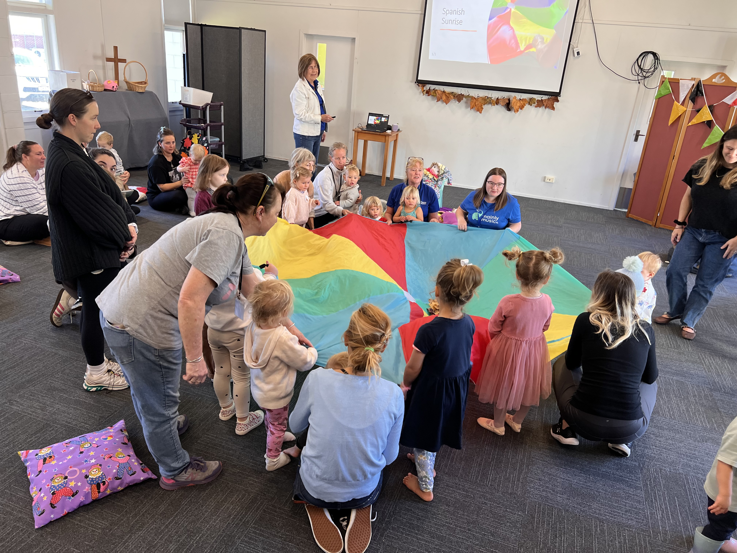 An image of adults and children at a Mainly Music session at St Andrews church.