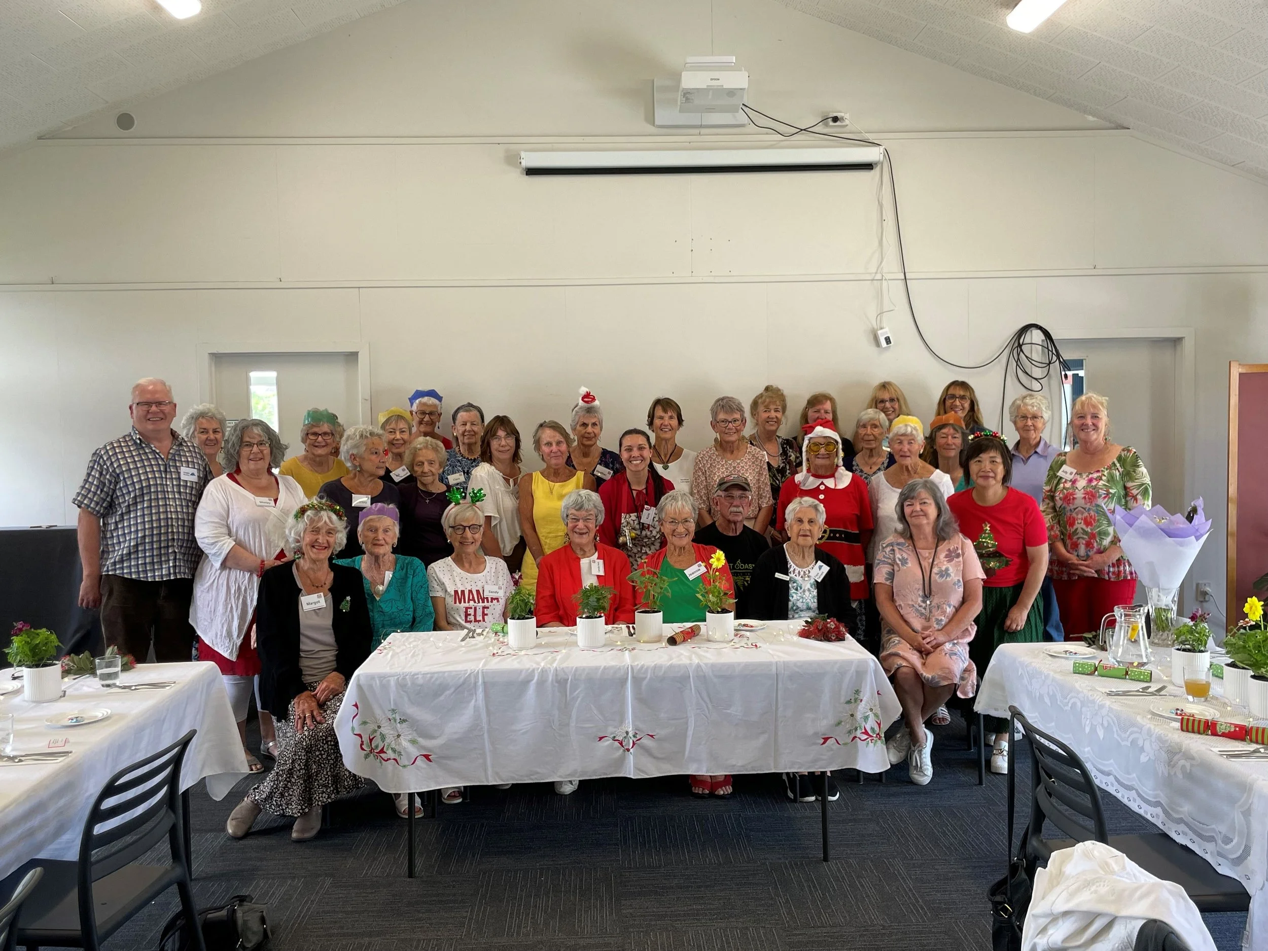 Group of op-shop volunteers gathered at a Christmas event, for St Andrews Presbyterian Church, Mt Maunganui, New Zealand