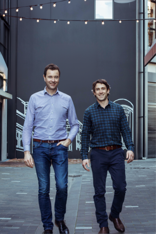 Photo of Guy Buchanan and David Pottinger, the founders of Vista Wealth & Protection (formally Optimalife and Buchanan Financial Partners) walking in a Christchurch laneway by Little High