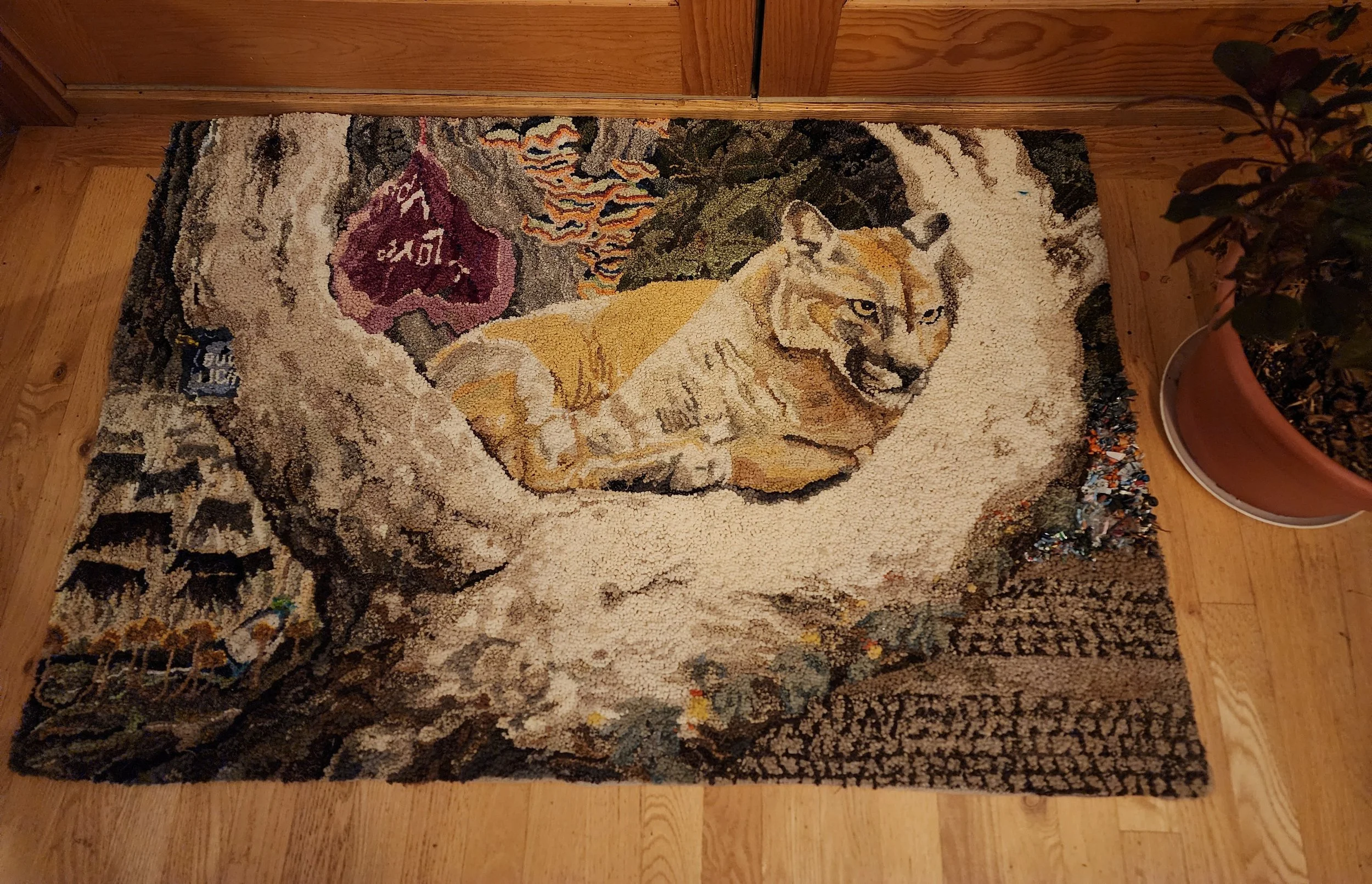 Lion's staycation  -  30x45"  repurposed and new wool, plastic refuse hooked rug/tapestry on linen