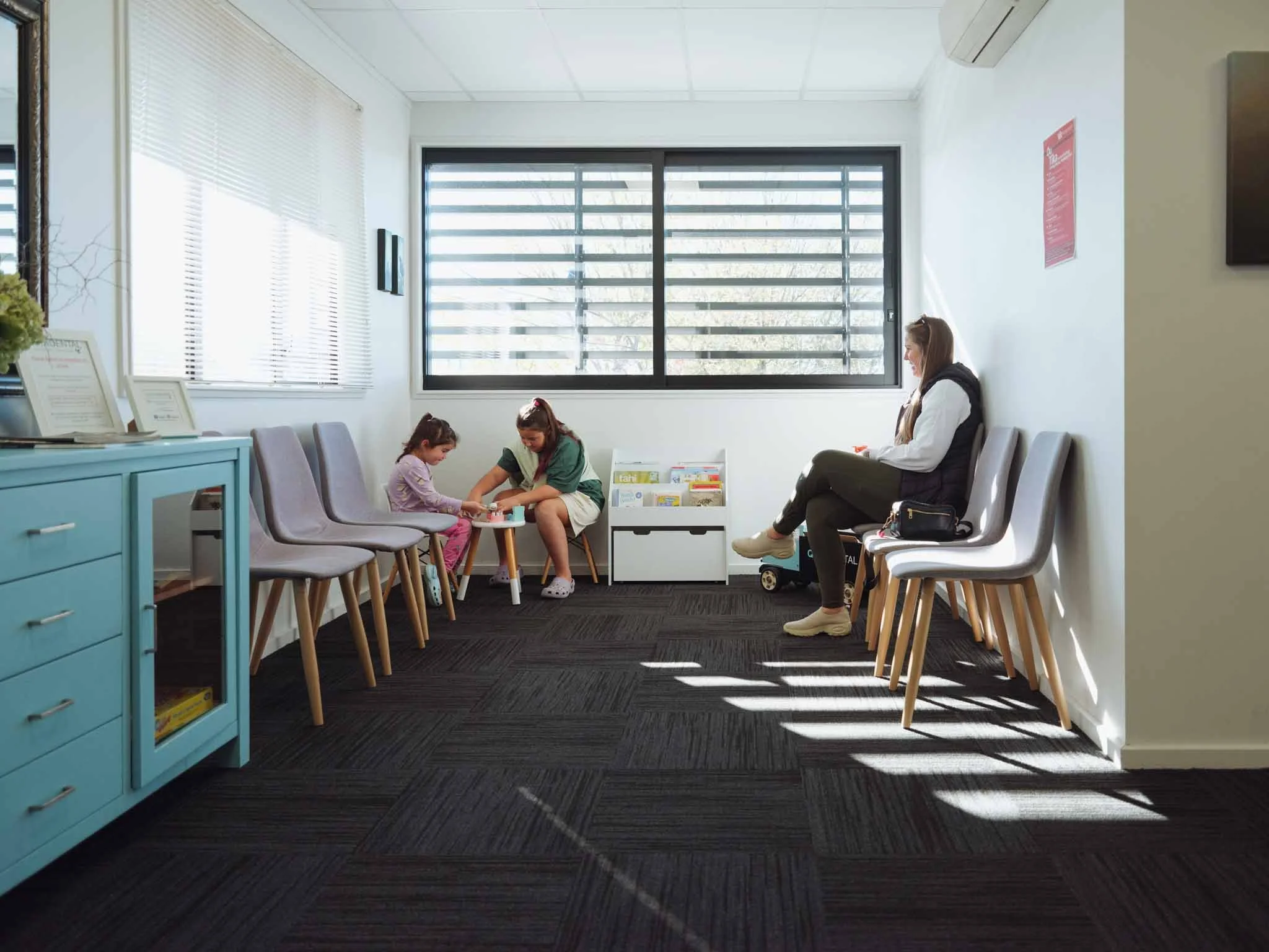A family in the waiting room at Quin Dental in Nelson, New Zealand.