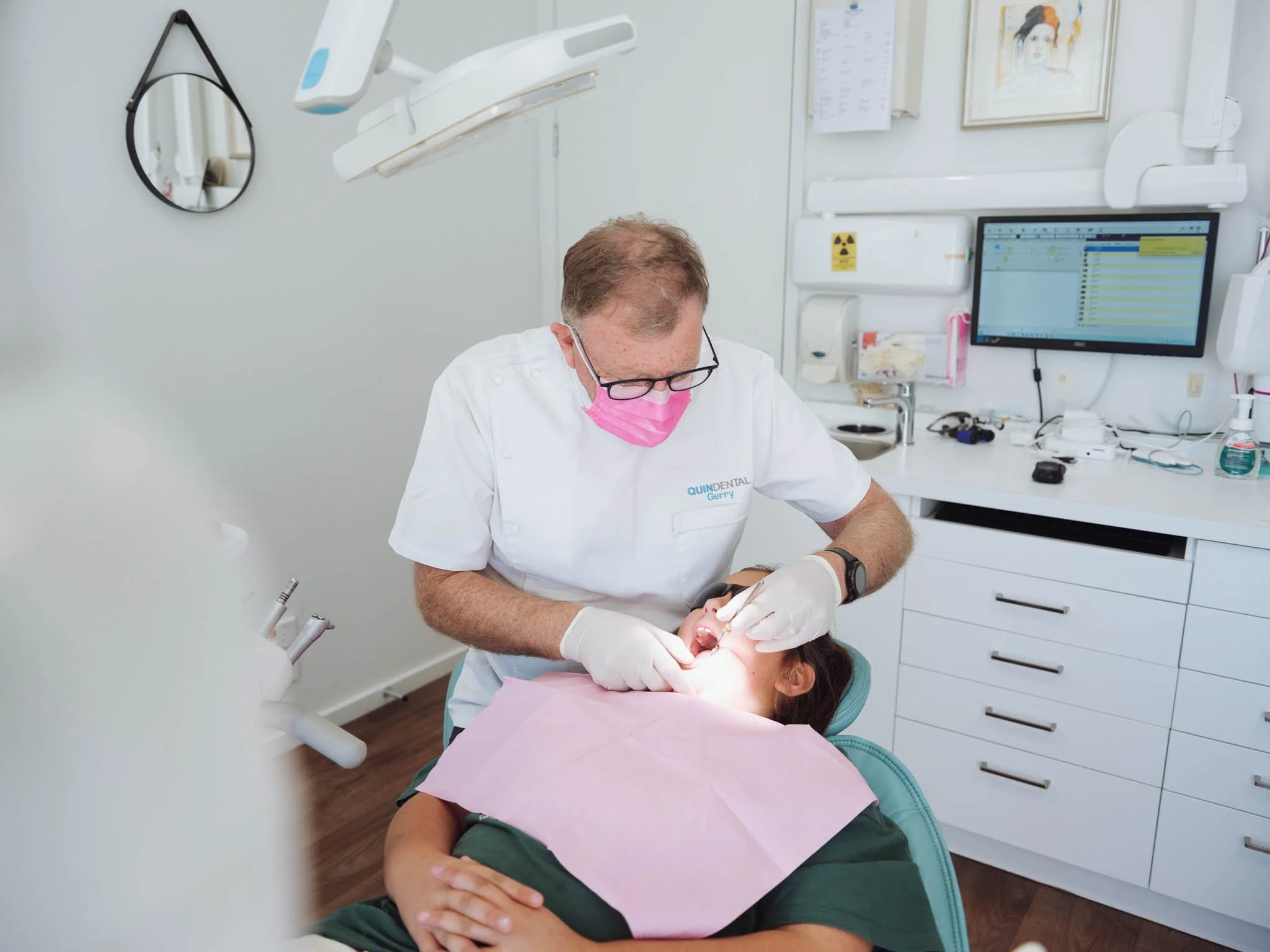 Dentist performs exam on child at Quin Dental, Nelson