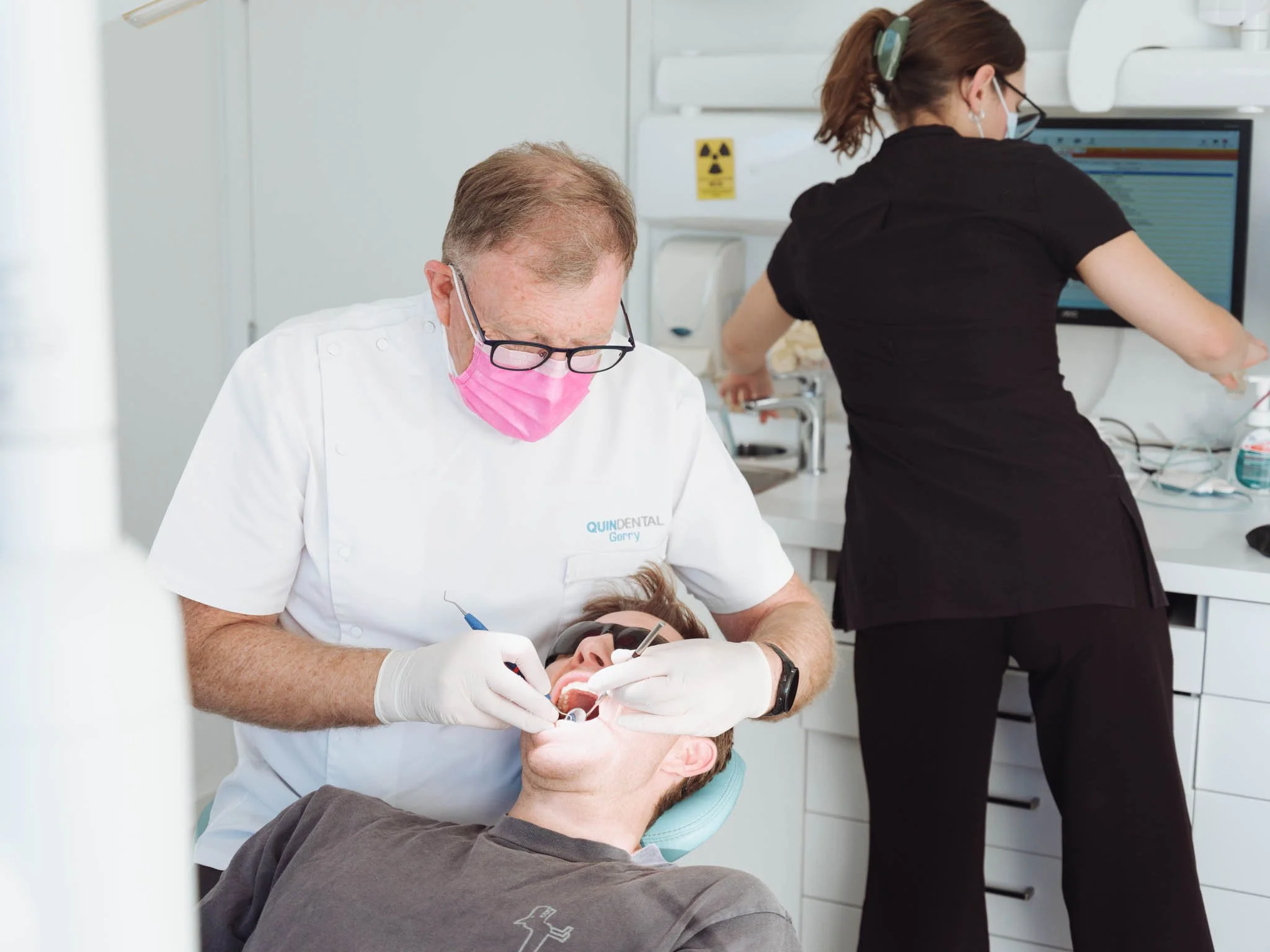 Gerry Quin and dental assistant perform dental exam at Quin Dental in Nelson, New Zealand.